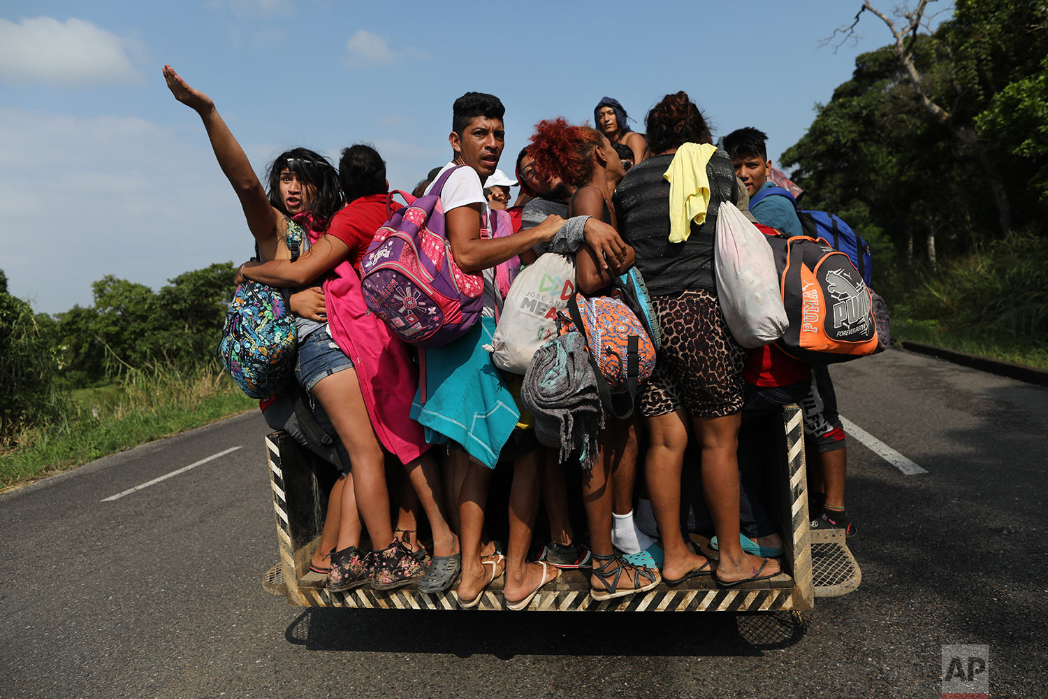  In this Nov. 2, 2018 photo, members of a group of 50 or so LGBTQ migrants traveling with the migrant caravan hoping to reach the U.S. border, hitch a ride on an overloaded utility truck to Sayula, Mexico.  (AP Photo/Rodrigo Abd)
 