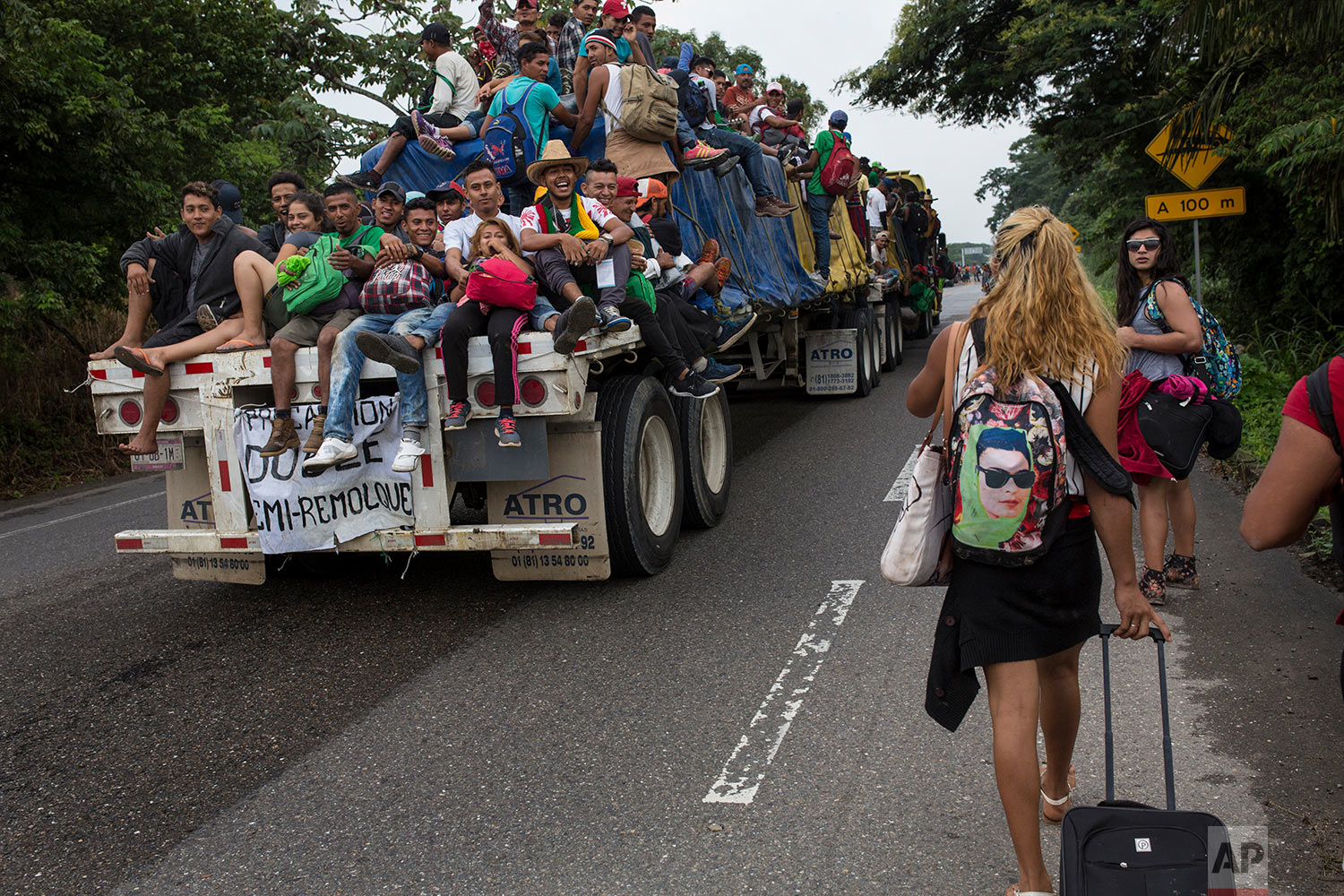  In this Nov. 2, 2018 photo, Central American migrants who hitched a ride on a flatbed truck jeer at members of about 50 LGBTQ migrants who are also part of the caravan hoping to reach the U.S. border, on the road to Donaji, Mexico. (AP Photo/Rodrigo