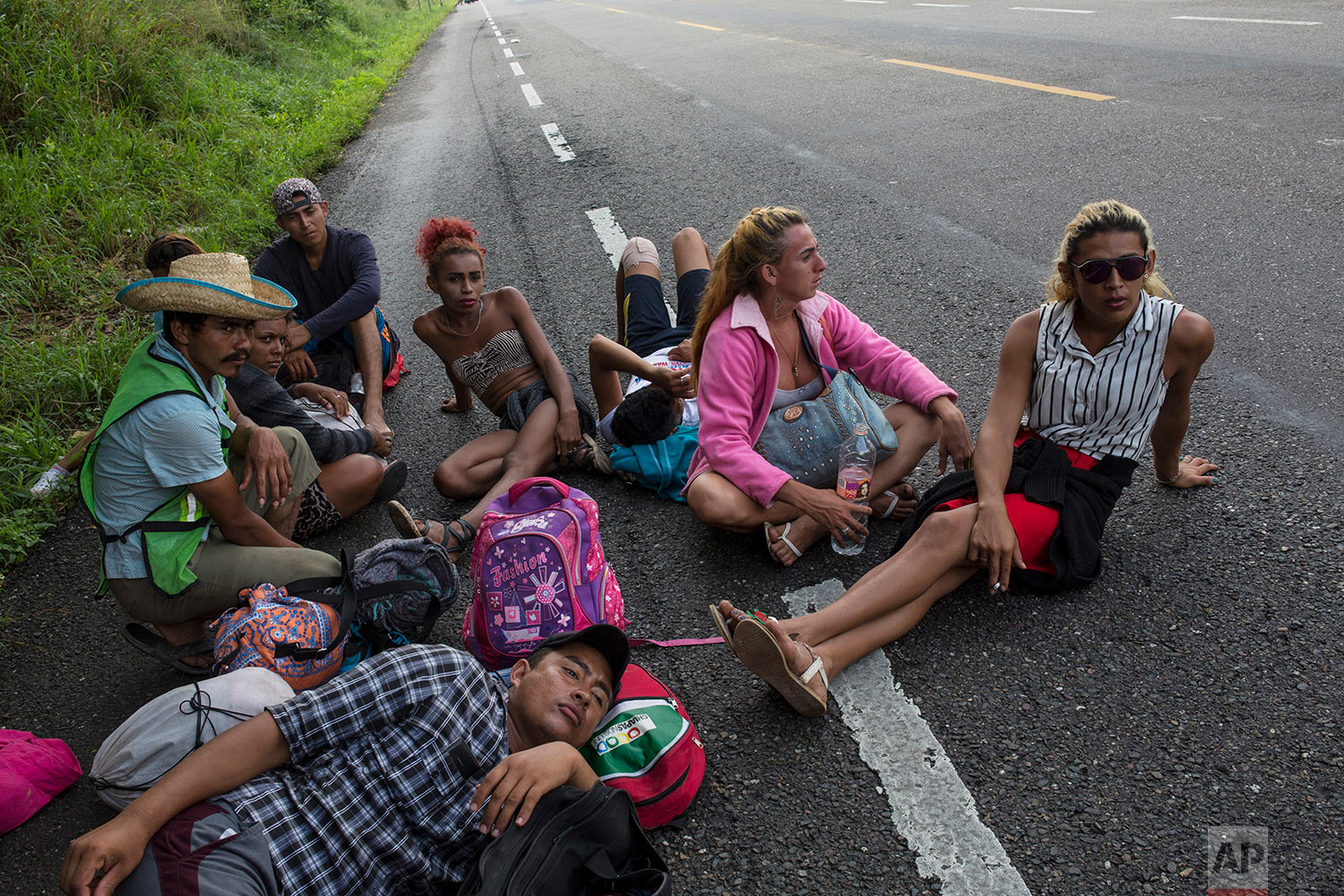  In this Nov. 2, 2018 photo, members of the LGBTQ community who are traveling with the Central American migrants caravan hoping to reach the U.S. border, wait on the side of the road for a ride to Donaji, Mexico. (AP Photo/Rodrigo Abd) 