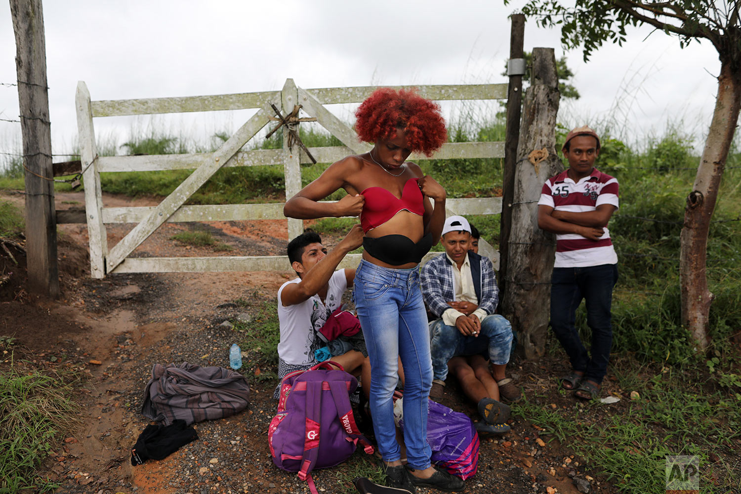  In this Nov. 3, 2018 photo, Honduran transgender Alexa Amaya, who is traveling with the migrant caravan hoping to reach the U.S. border, tries on a pushup bra she selected from a pile of donated clothing left alongside the road to Sayula, Mexico. (A