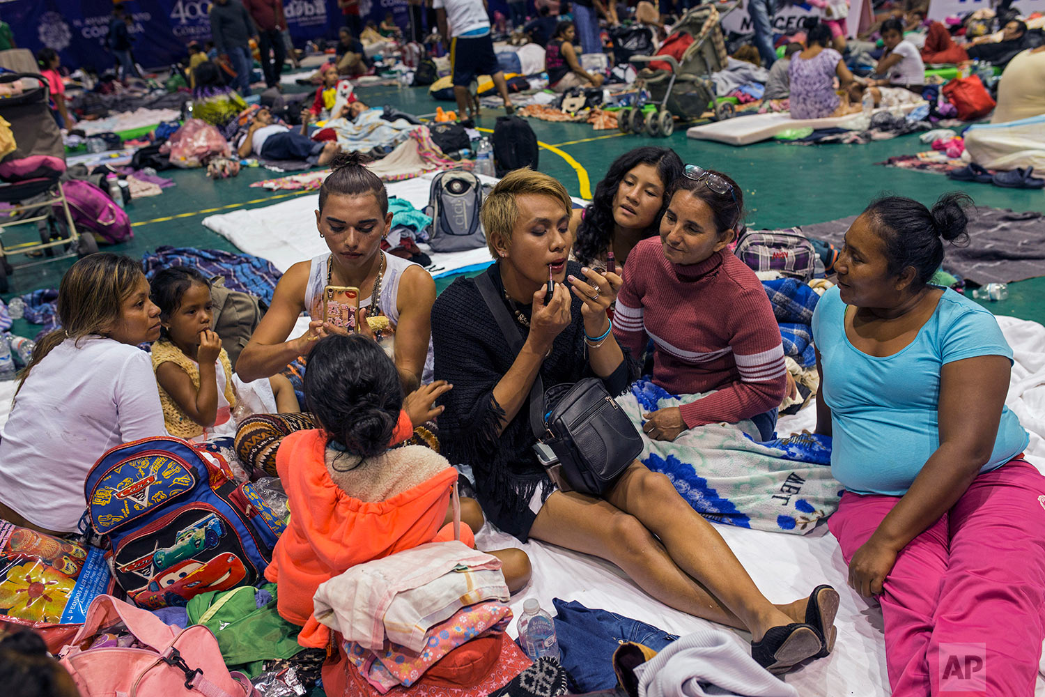  In this Nov. 4, 2018 photo, two transgender women who are part of a group of 50 or so LGBTQ migrants traveling with the migrant caravan hoping to reach the U.S. border, apply face makeup at a shelter in Cordoba, Mexico. (AP Photo/Rodrigo Abd)
 