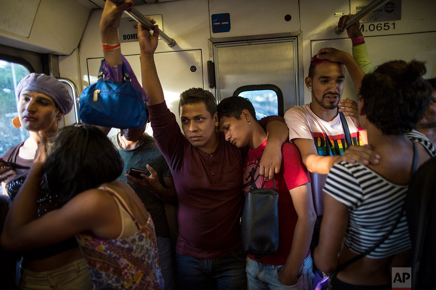  In this Nov. 8, 2018 photo, members of a group of 50 or so LGBTQ migrants traveling with the migrant caravan hoping to reach the U.S. border, ride the subway during a rest day, to the historic center in Mexico City. (AP Photo/Rodrigo Abd)
 