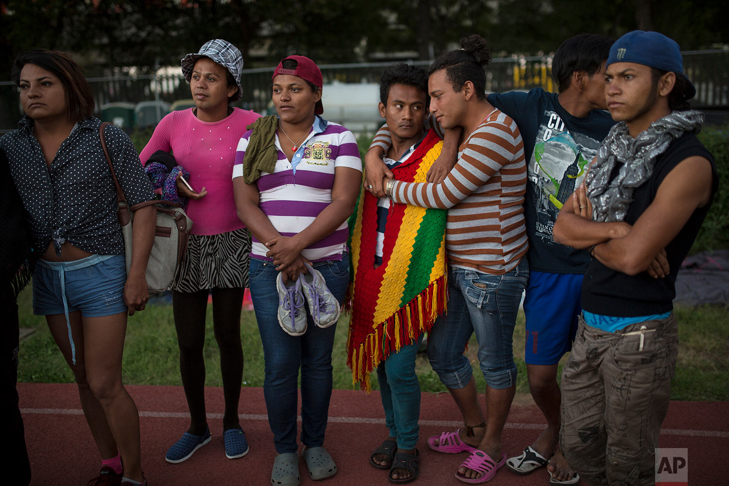  In this Nov. 4, 2018 photo, members of a group of 50 or so LGBTQ migrants, stand on the race track at the Jesus Martinez stadium that was  turned into a makeshift shelter, in Mexico City. (AP Photo/Rodrigo Abd)
 