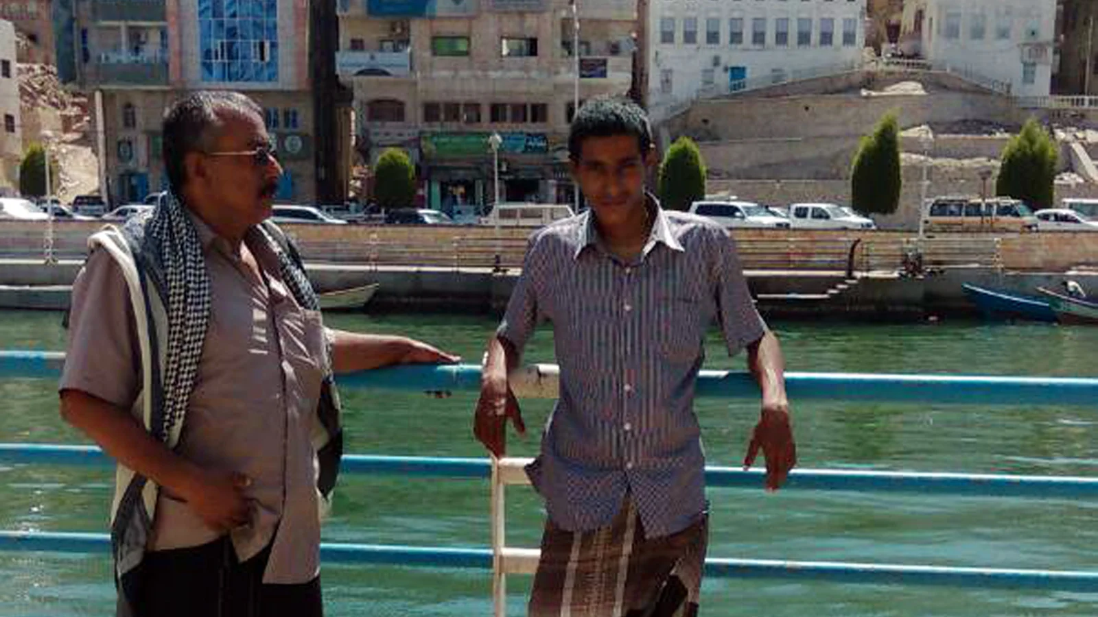 Abdullah, right, and his father pose for a photograph in the coastal city of Mukalla, Yemen. (Saleh family via AP)