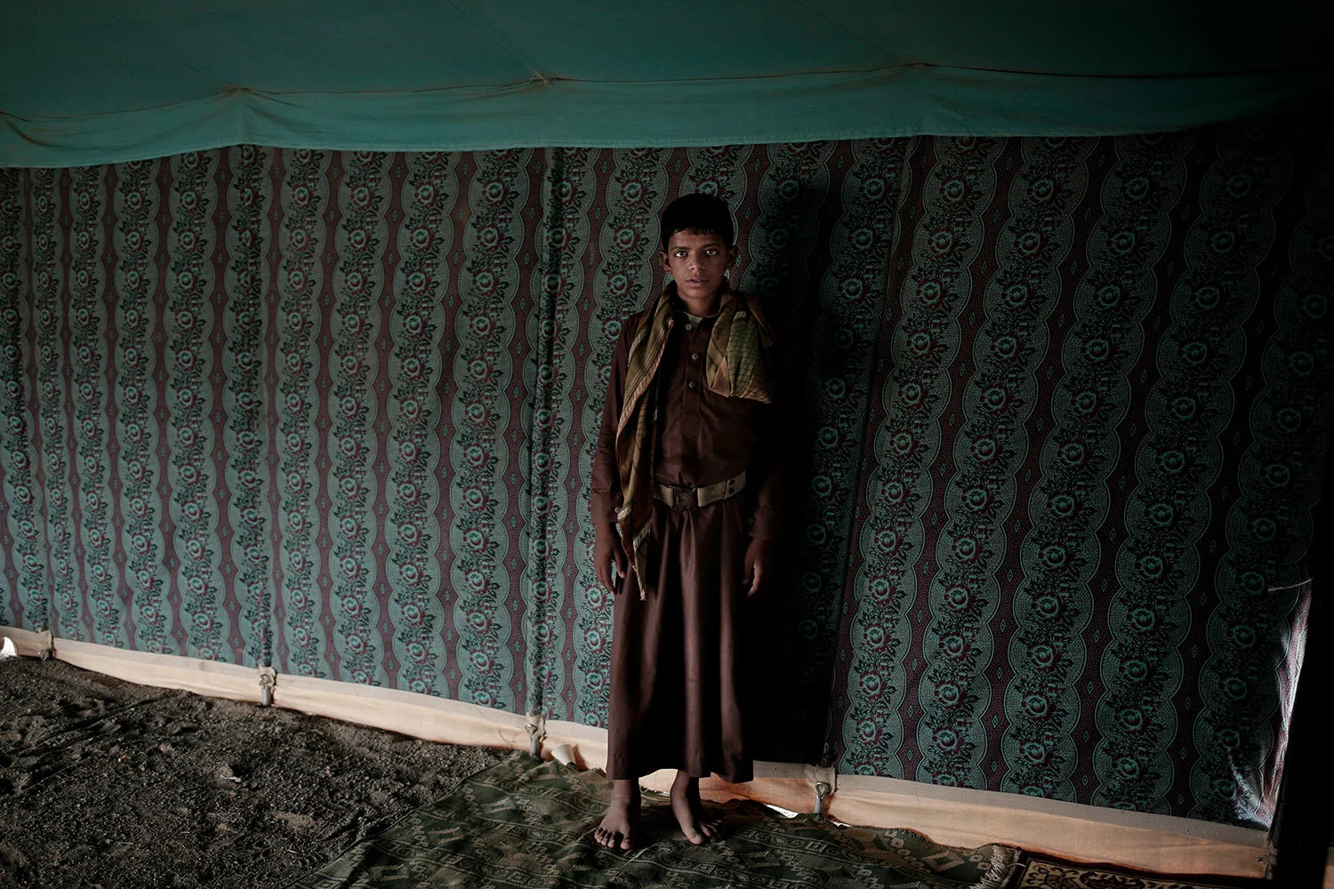 In this July 27, 2018 photo, 15 year-old Nawaf Mohammed, poses for a photograph at a camp for displaced persons where he took shelter with his family, in Marib, Yemen, (AP Photo/Nariman El-Mofty)