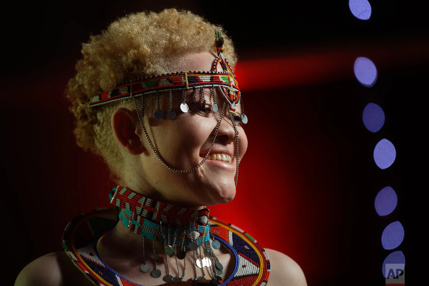 Kenyan contestant Lucianah Nyawira, 21, wears a traditional costume as she performs in the Mr. & Miss Albinism East Africa contest, organized by the Albinism Society of Kenya, in Nairobi, Kenya, Nov. 30, 2018. (AP Photo/Ben Curtis)