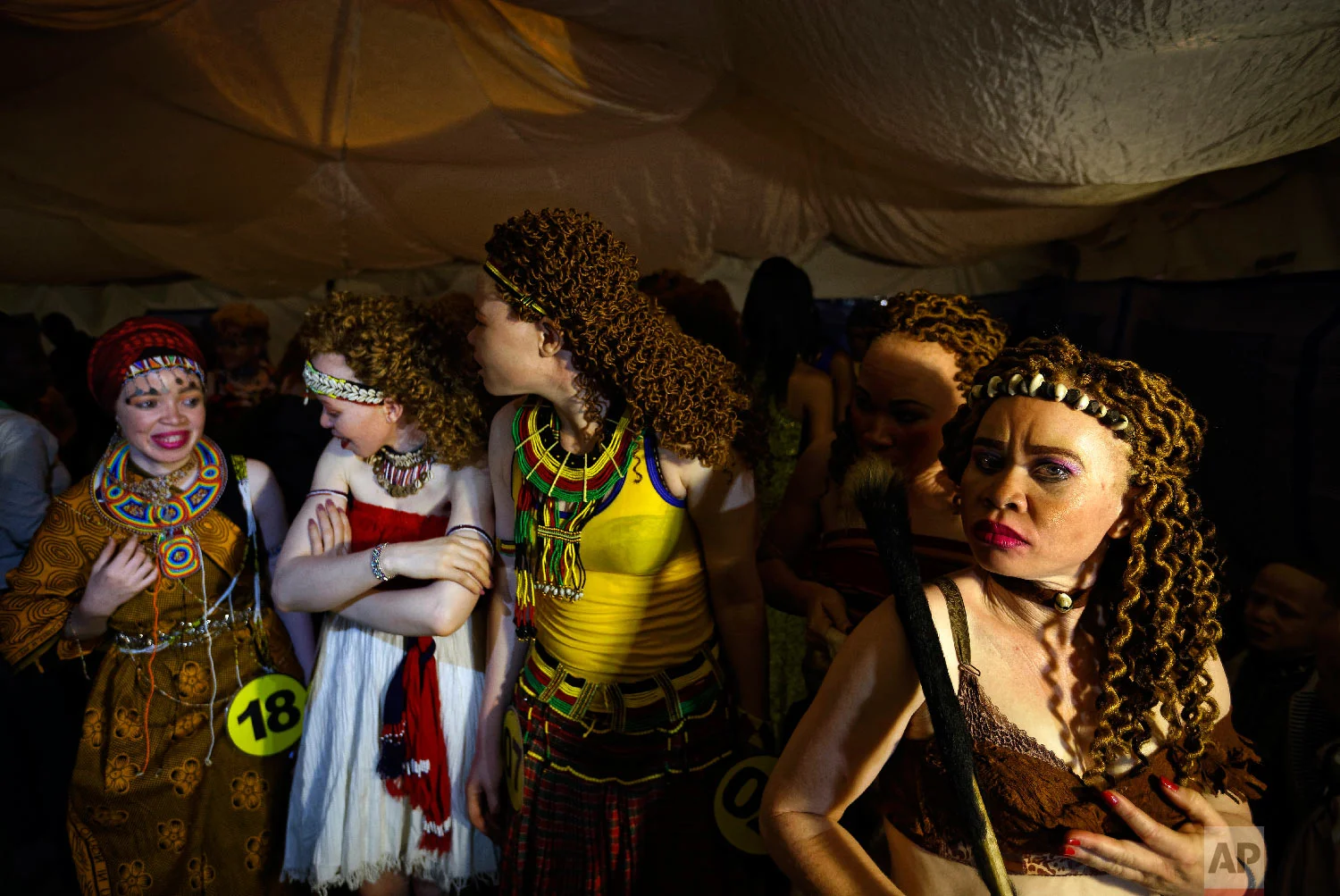 Contestants queue up to take the stage in the Mr. & Miss Albinism East Africa contest, organized by the Albinism Society of Kenya, in Nairobi, Kenya, Nov. 30, 2018. (AP Photo/Ben Curtis)