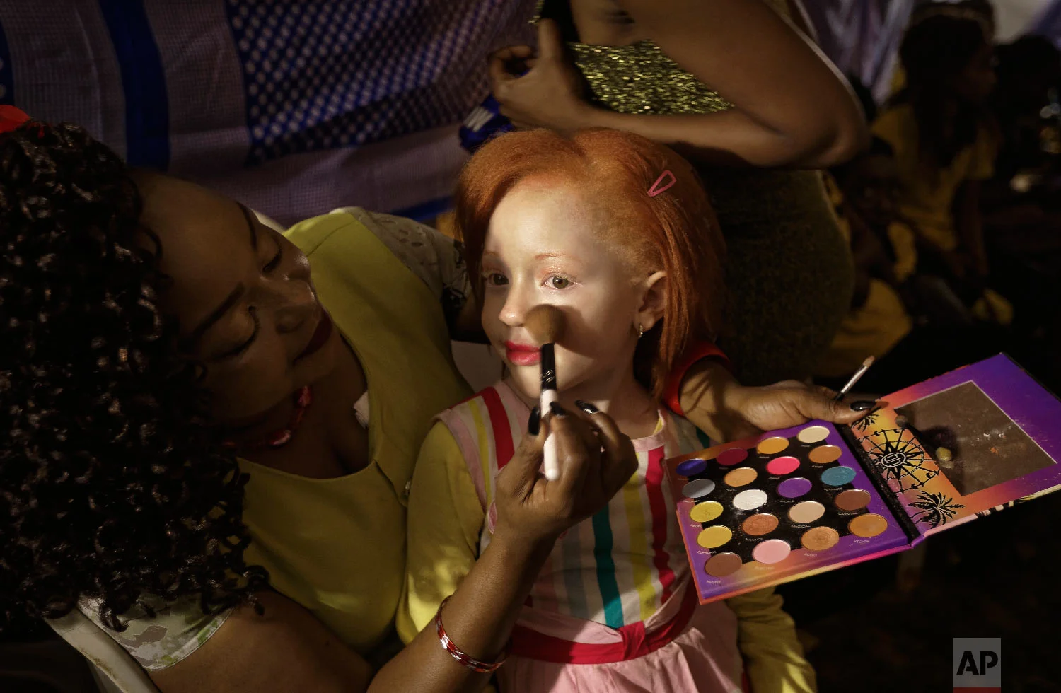 Elsie Lynn, 6, has her makeup done a she waits for the start of the Mr. & Miss Albinism East Africa contest, organized by the Albinism Society of Kenya, in Nairobi, Kenya, Nov. 30, 2018. (AP Photo/Ben Curtis)