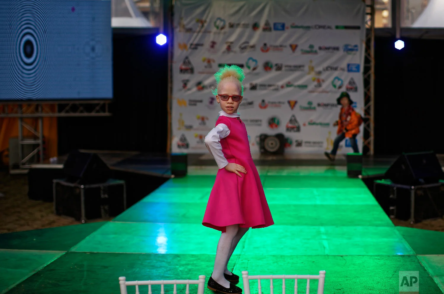Shirlyne 7, tries her hand on the catwalk before the start of the Mr. & Miss Albinism East Africa contest, organized by the Albinism Society of Kenya, in Nairobi, Kenya, Nov. 30, 2018. (AP Photo/Ben Curtis)