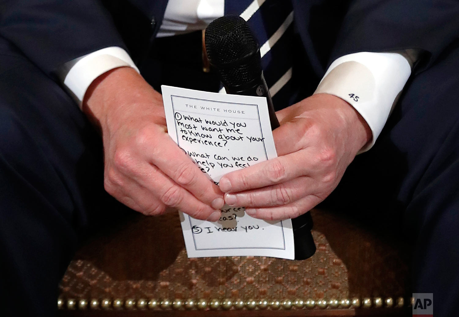  President Donald Trump holds notes during a listening session with high school students and teachers at the White House in Washington on Feb. 21, 2018. Trump heard the stories of students and parents affected by school shootings, one week after the 