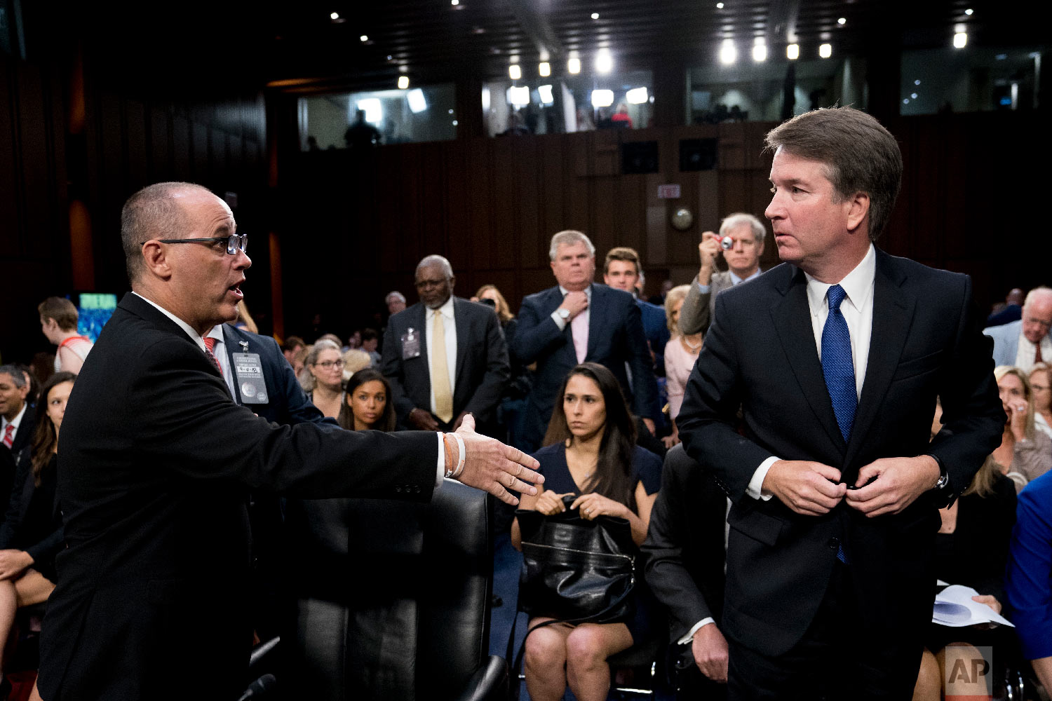  Fred Guttenberg, left, the father of Jamie Guttenberg, who was killed in the high school shooting in Parkland, Fla., attempts to shake hands with Brett Kavanaugh, President Donald Trump's Supreme Court nominee, as he leaves for a lunch break during 