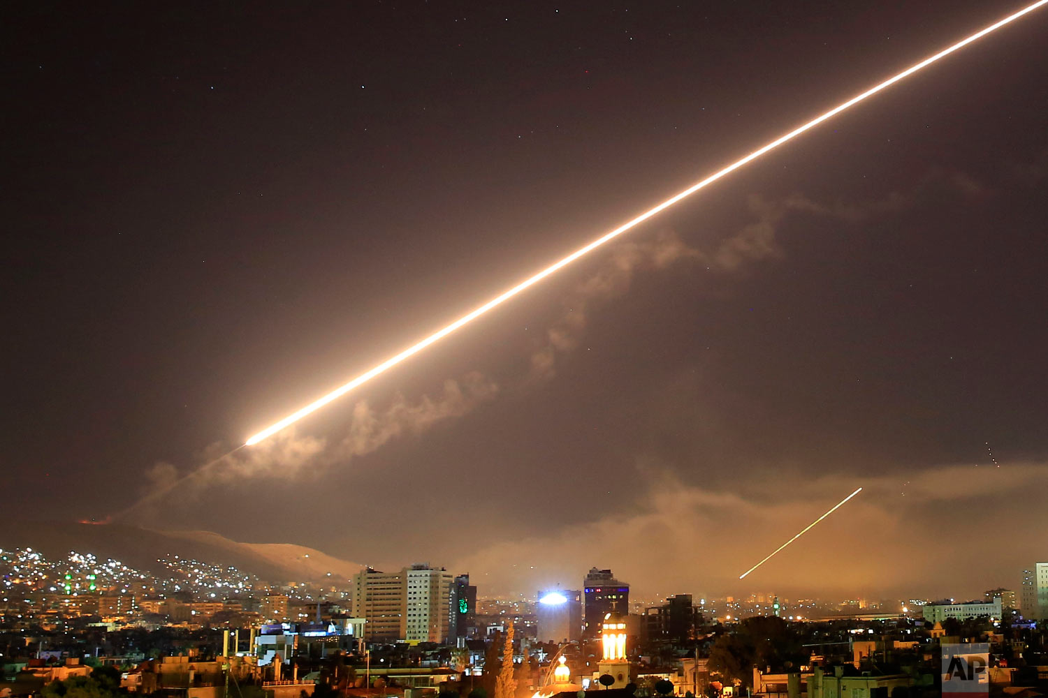  Surface to air missile fire lights up the sky over Damascus at the U.S. launches an attack on Syria early on April 14, 2018. U.S. President Donald Trump ordered the airstrikes in retaliation for Syria's alleged use of chemical weapons. (AP Photo/Has