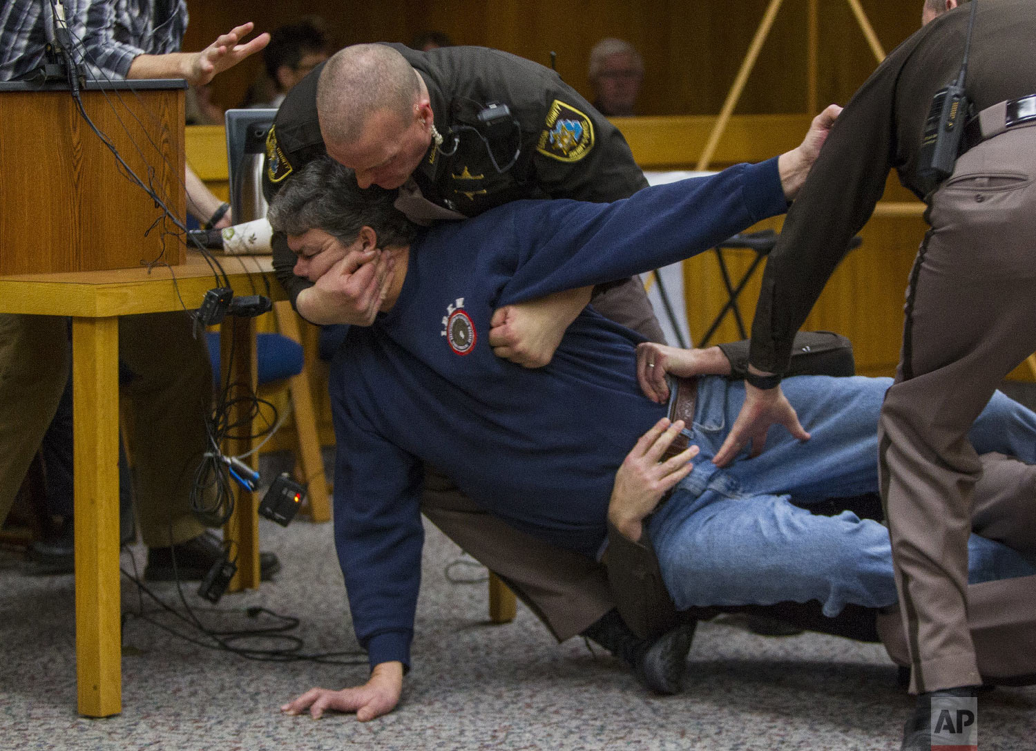  Eaton County Sheriff's deputies restrain Randall Margraves, father of three victims of Larry Nassar, on Feb. 2, 2018, in Eaton County Circuit Court in Charlotte, Mich. The incident came during the third and final sentencing hearing for Nassar on sex