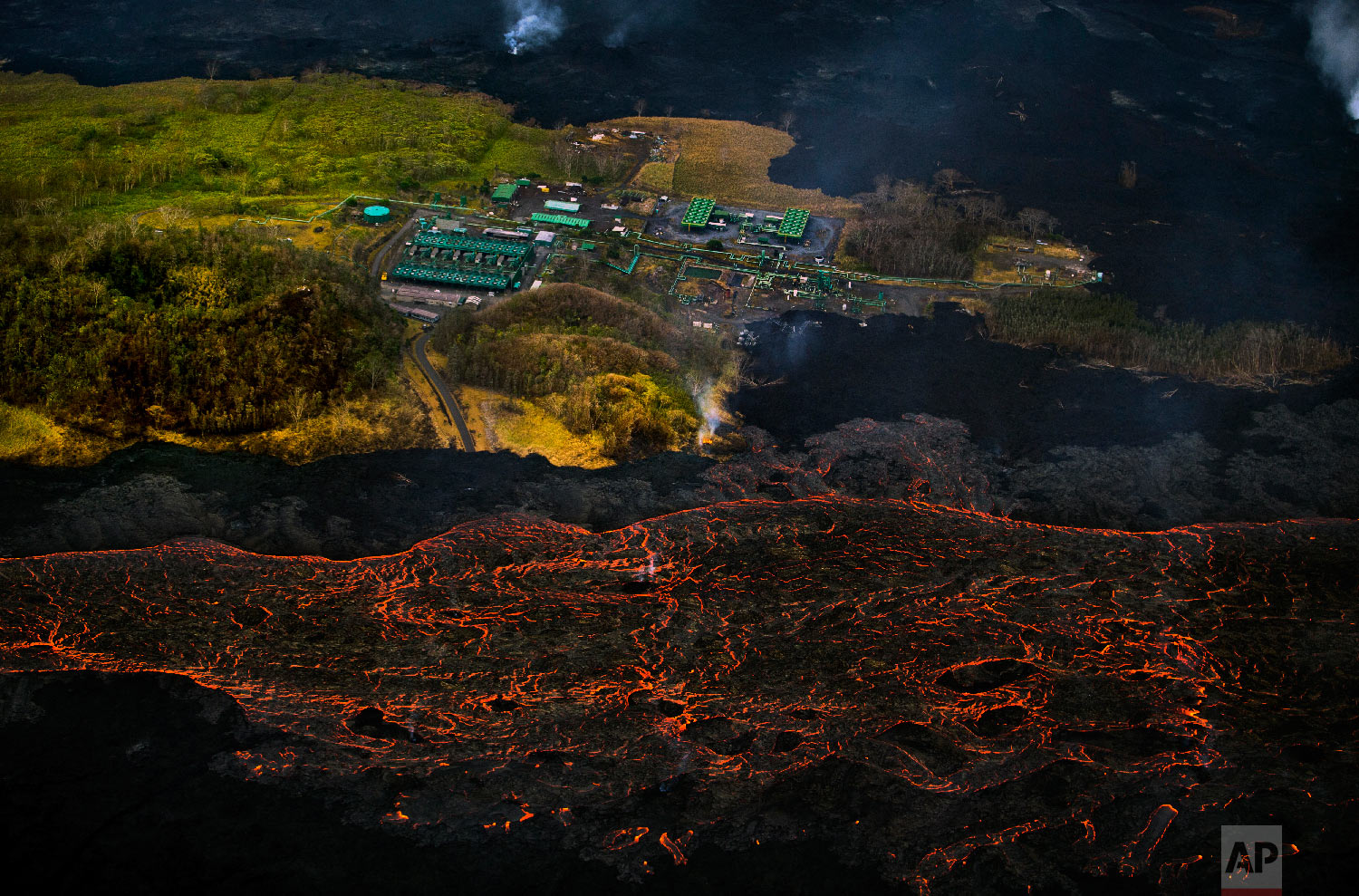  Lava from the Kilauea volcano flows near the Puna Geothermal Venture power plant in Pahoa, Hawaii, on June 10, 2018. (AP Photo/L.E. Baskow) 