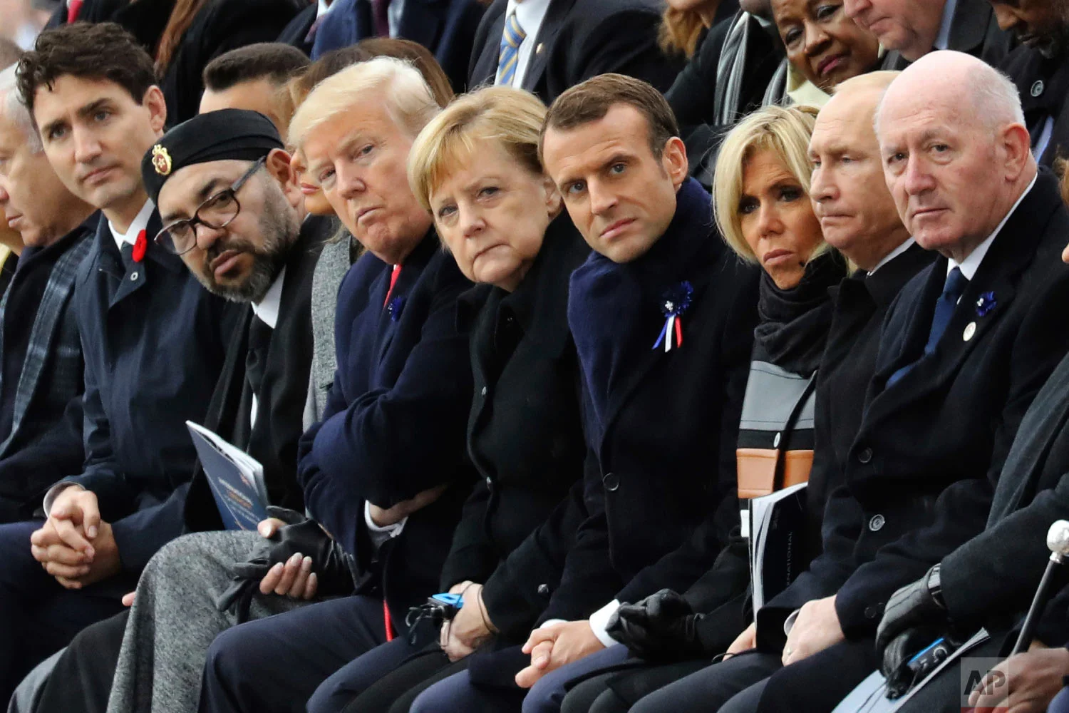 World leaders, from left, Canadian Prime Minister Justin Trudeau, Morocco's Prince Moulay Hassan, Moroccan King Mohammed VI, U.S. first lady Melania Trump, U.S. President Donald Trump, German Chancellor Angela Merkel, French President Emmanuel Macron and his wife Brigitte Macron, Russian President Vladimir Putin and Australian Governor-General Peter Cosgrove attend a ceremony at the Arc de Triomphe in Paris as part of the commemorations marking the 100th anniversary of the Nov. 11, 1918, armistice, which ended World War I, on Sunday, Nov. 11, 2018. (Ludovic Marin/Pool Photo via AP)