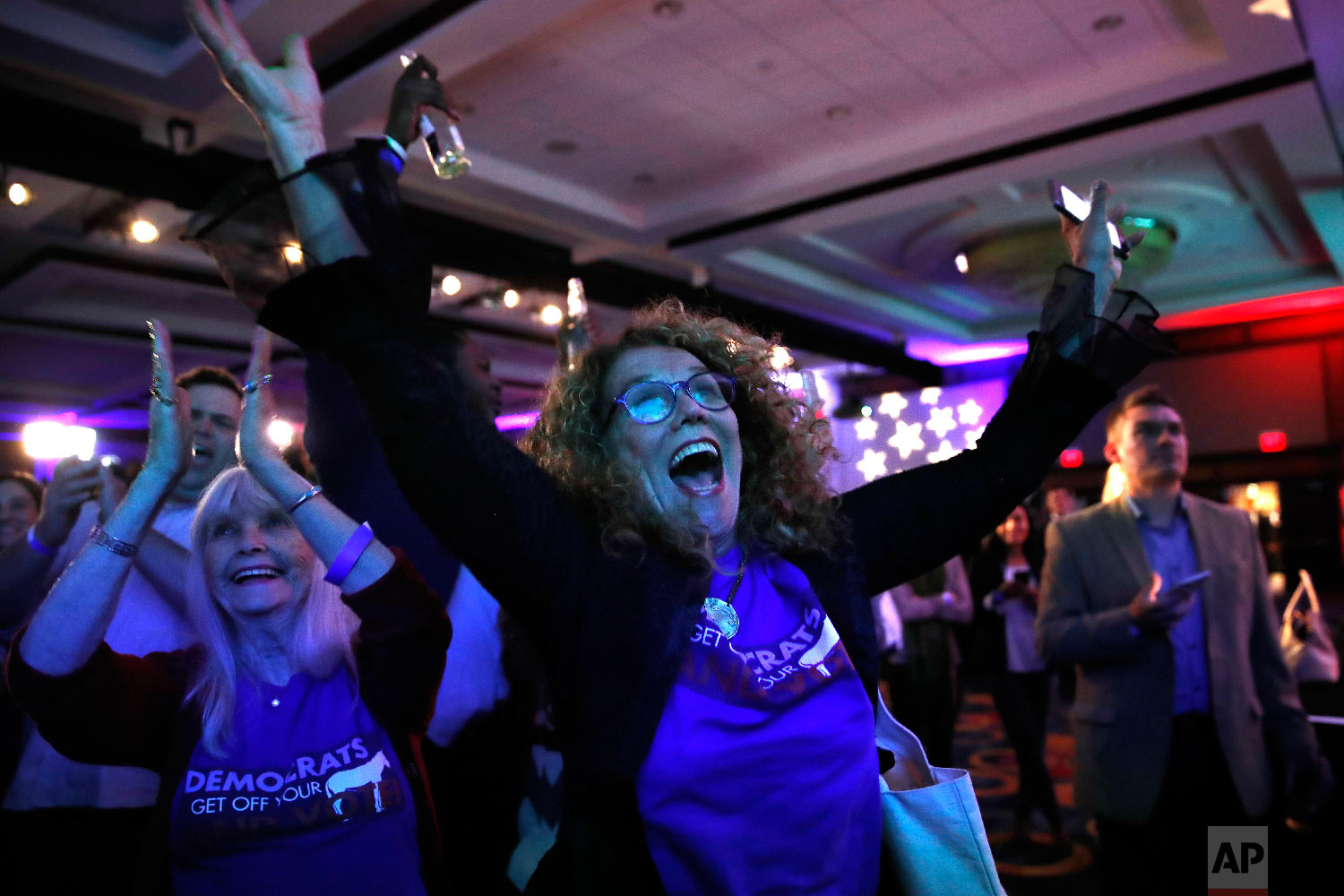  Sydney Crawford, 84, left, of New York, and JoAnn Loulan, 70, of Portola Valley, Calif., cheer as election returns come in during a Democratic party election night event at the Hyatt Regency Hotel in Washington on Tuesday, Nov. 6, 2018. (AP Photo/Ja