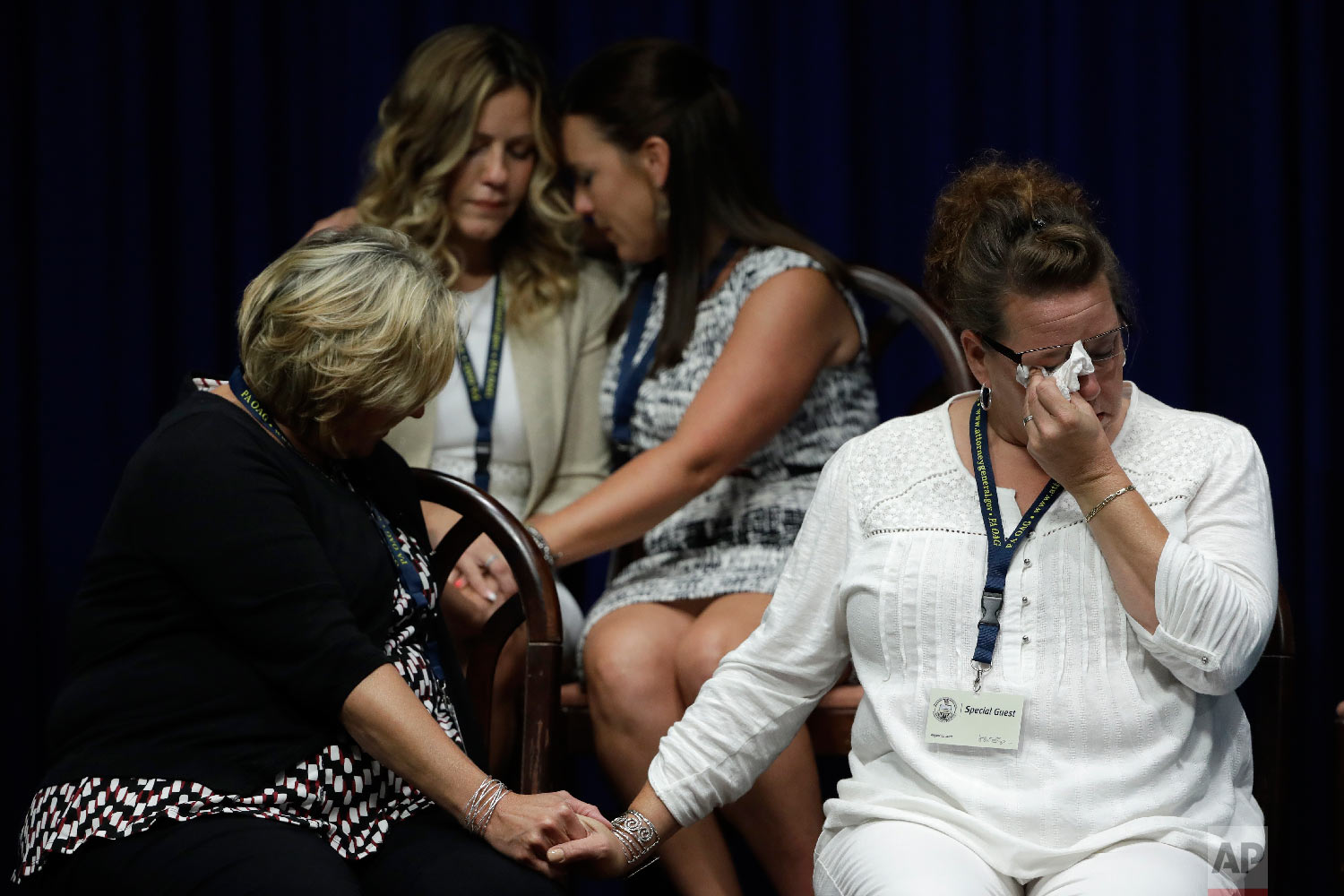  Victims of clergy sexual abuse, or their family members, react as Pennsylvania Attorney General Josh Shapiro speaks during a news conference at the State Capitol in Harrisburg, Pa., on Aug. 14, 2018. A Pennsylvania grand jury says its investigation 