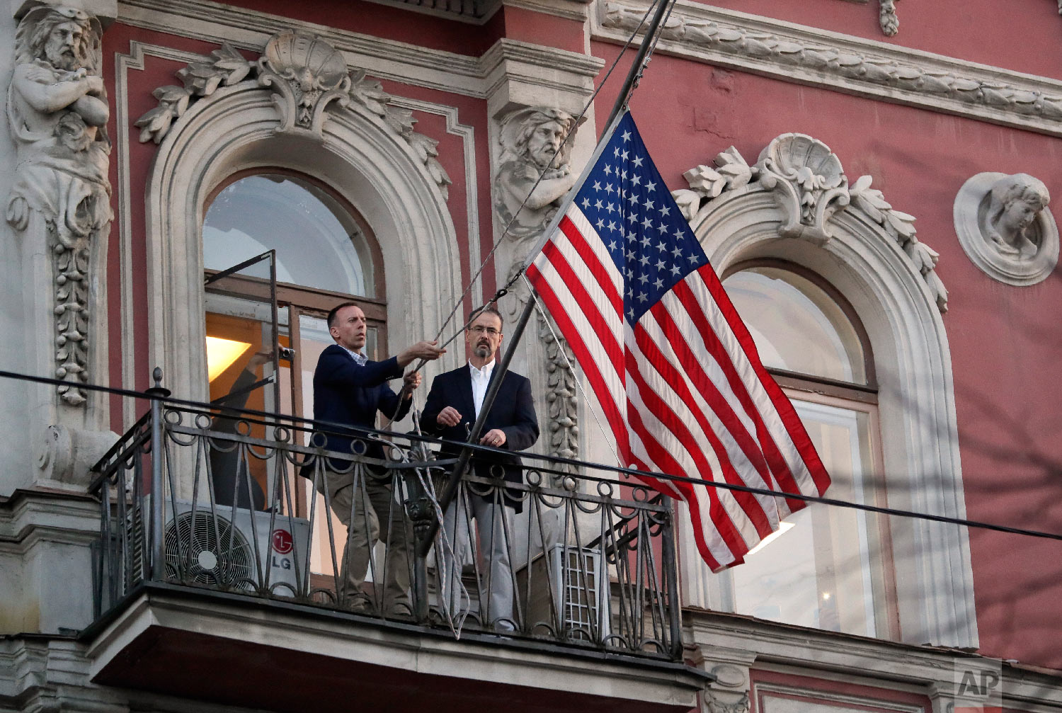  Employees at the U.S. consulate in St. Petersburg, Russia, remove the U.S flag on March 31, 2018, after Russia announced it was closing the consulate and expelling more than 150 diplomats, including 60 Americans. The move was in retaliation for the 