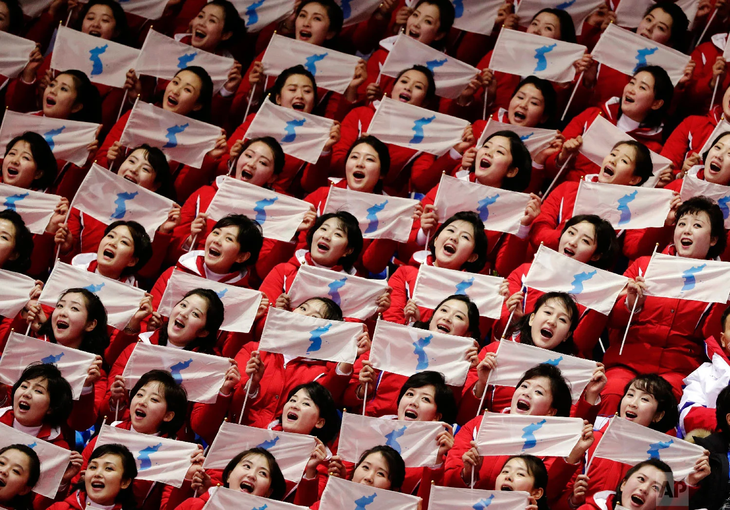 North Korean supporters hold up Korean unification flags during the ladies' 500 meters short-track speedskating at the 2018 Winter Olympics in Gangneung, South Korea, on Feb. 10, 2018. (AP Photo/Julie Jacobson)