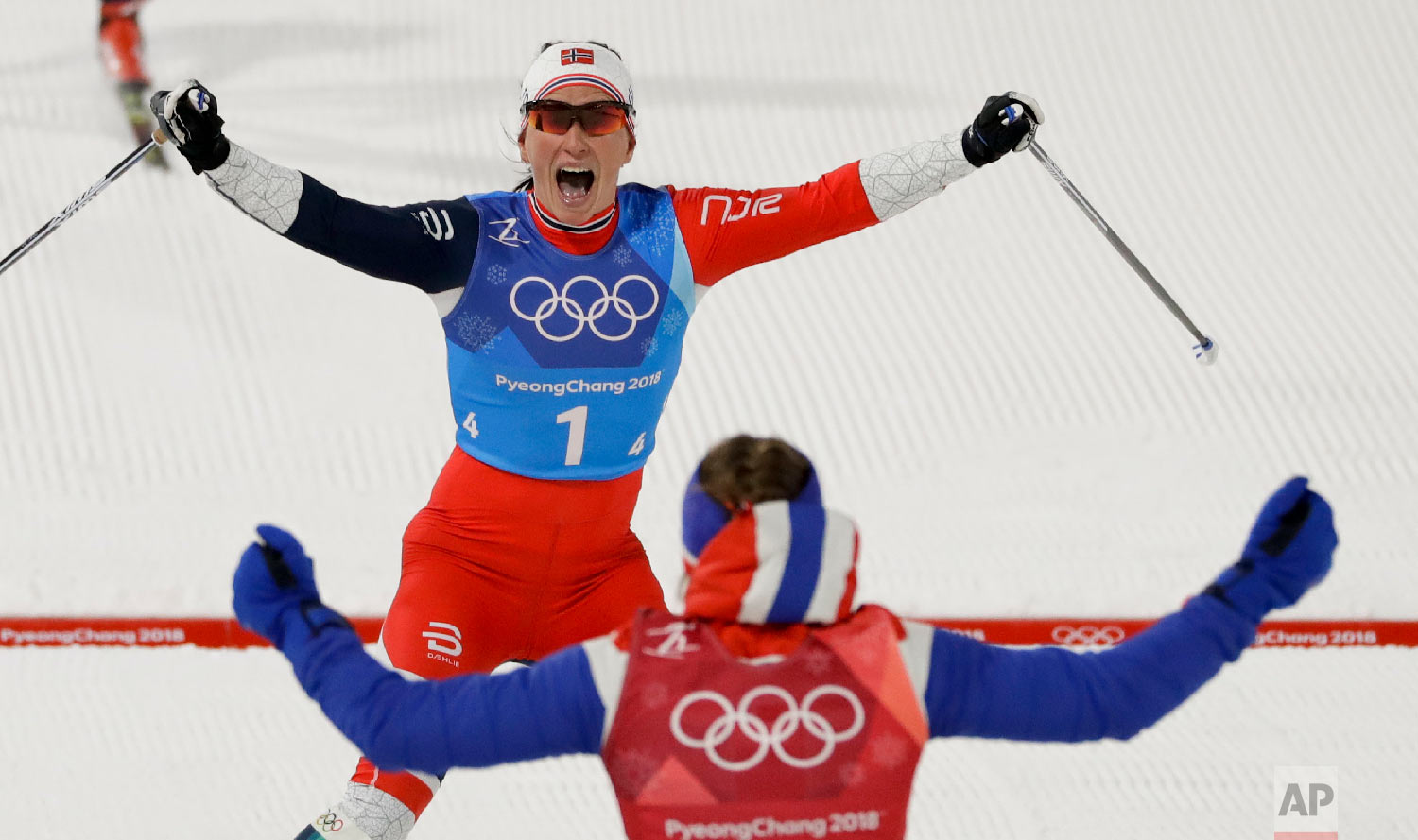  Marit Bjoergen, top, of Norway, celebrates with teammate Ingvild Flugstad Oestberg after winning the women's 4 x 5km relay cross-country skiing competition at the 2018 Winter Olympics in Pyeongchang, South Korea, on Feb. 17, 2018. (AP Photo/Kirsty W