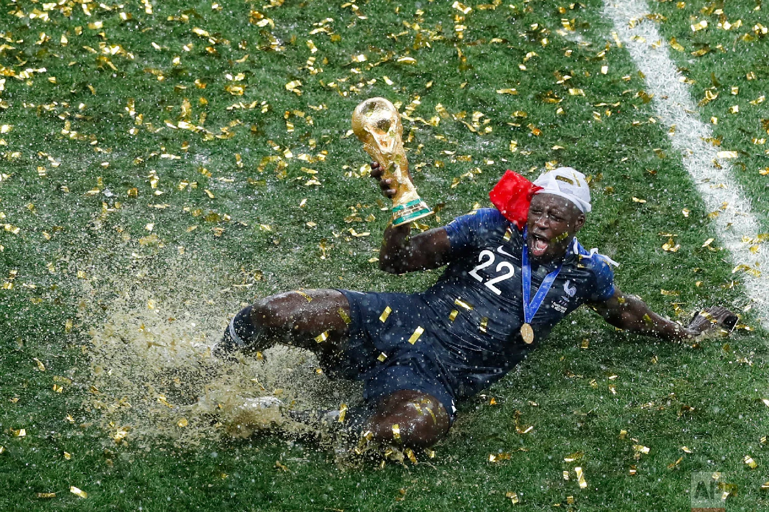 France's Benjamin Mendy celebrates with the trophy after his team won the final match against Croatia at the 2018 soccer World Cup in the Luzhniki Stadium in Moscow, Russia, on July 15, 2018. (AP Photo/Rebecca Blackwell)