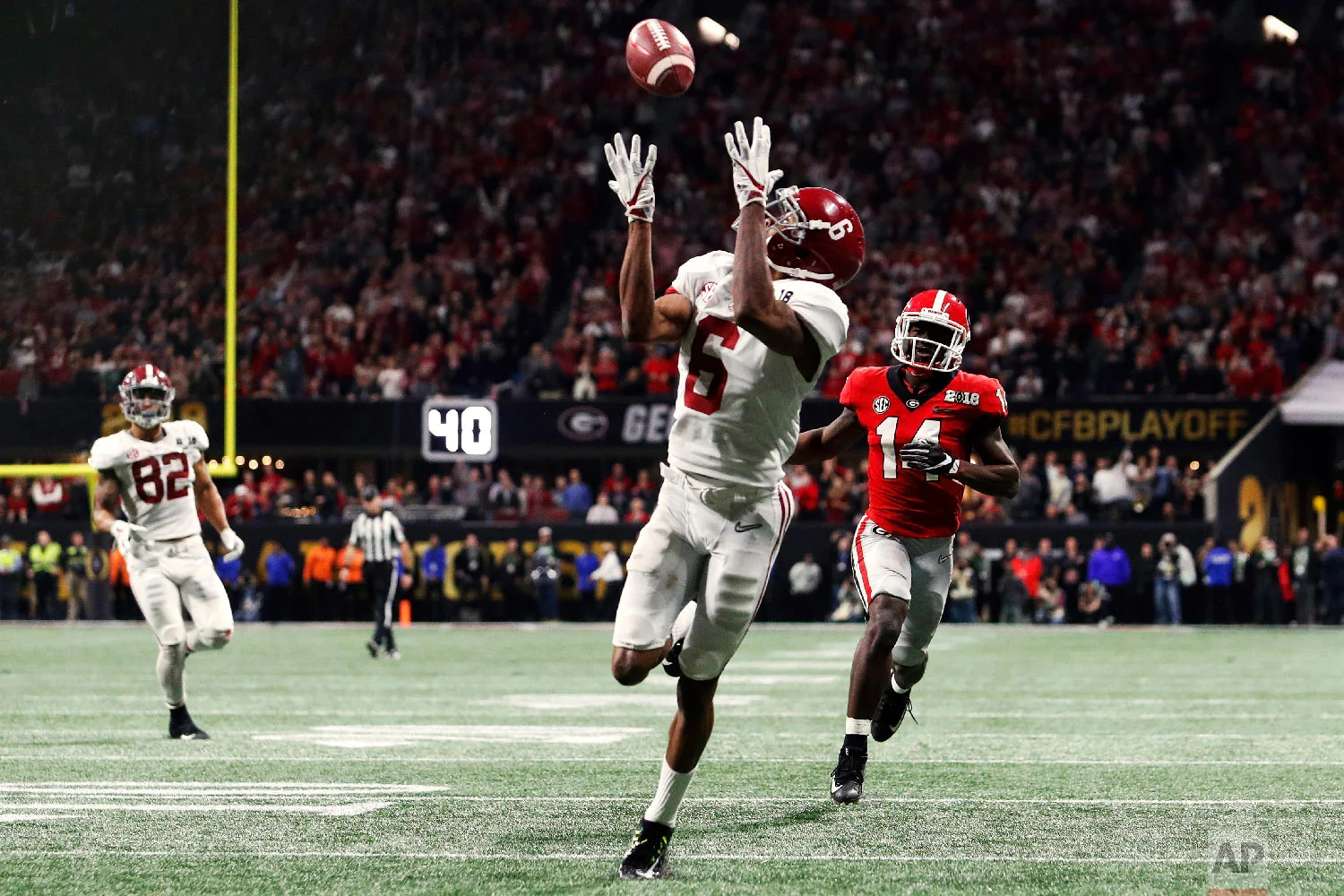 Alabama wide receiver DeVonta Smith (6) scores the game-winning touchdown in overtime during the College Football Playoff National Championship game between Georgia and Alabama on Jan. 8, 2018, in Atlanta, Ga. (AJ Reynolds/Athens Banner-Herald via AP)