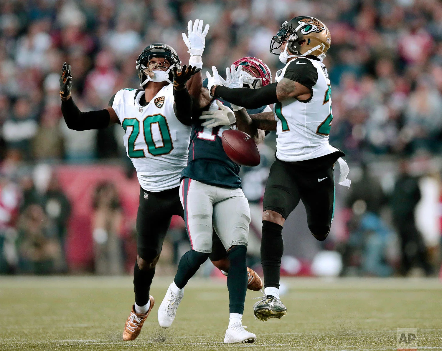 Jacksonville Jaguars cornerbacks Jalen Ramsey (20) and A.J. Bouye (21) break up a pass intended for New England Patriots wide receiver Brandin Cooks during the second half of the AFC championship NFL football game on Jan. 21, 2018, in Foxborough, Mass. (AP Photo/Charles Krupa)