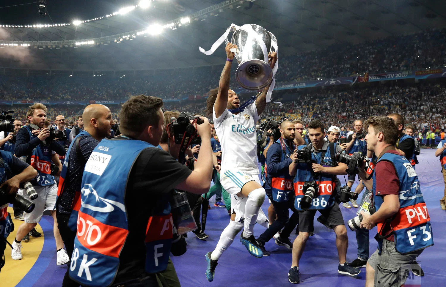 Real Madrid's Marcelo celebrates with the trophy after winning the Champions League Final soccer match against Liverpool at the Olimpiyskiy Stadium in Kiev, Ukraine, on May 26, 2018. (AP Photo/Matthias Schrader)