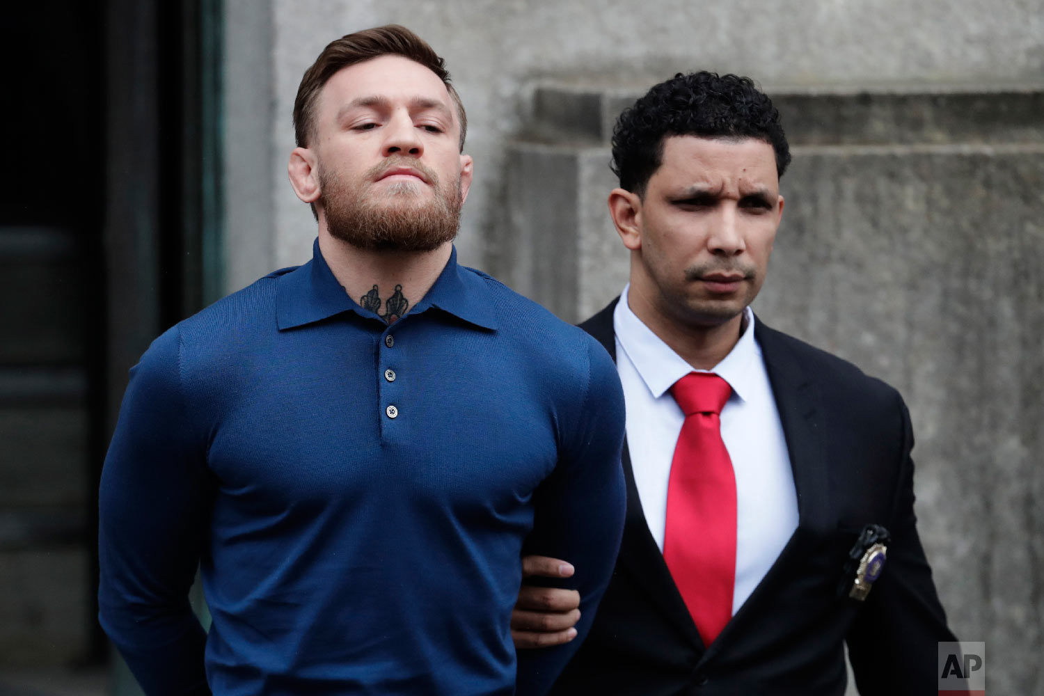  Ultimate fighting star Conor McGregor is led out of the 78th Police Precinct in the Brooklyn borough of New York on April 6, 2018, after his arrest following a backstage melee that forced the removal of three fights from UFC's biggest card of the ye