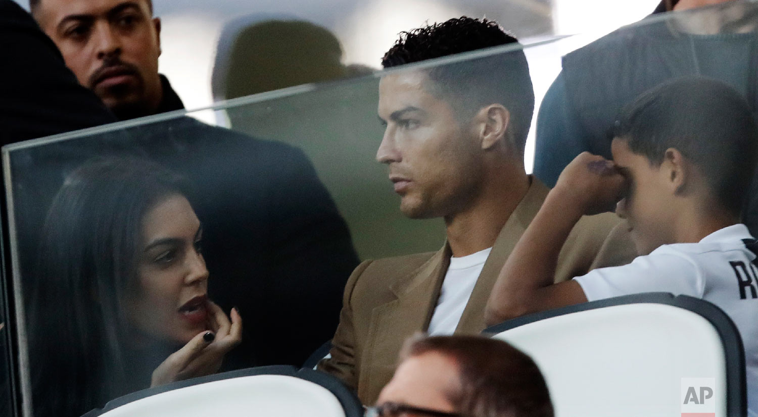  Juventus forward Cristiano Ronaldo, center, is flanked by his girlfriend Georgina, left, and his son Cristiano Jr., as he sits in the stands during a Champions League group H soccer match between Juventus and Young Boys, at the Allianz stadium in Tu