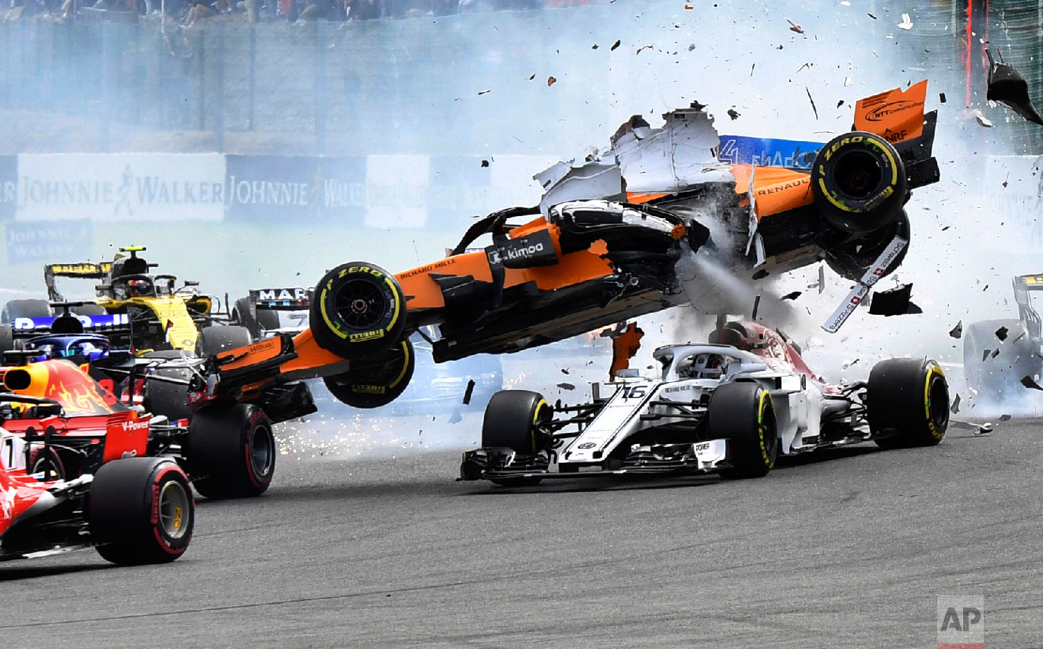  Mclaren driver Fernando Alonso of Spain goes over the top of Sauber driver Charles Leclerc of Monaco at the start of the Belgian Formula One Grand Prix in Spa-Francorchamps, Belgium, on Aug. 26, 2018. (AP Photo/Geert Vanden Wijngaert) 