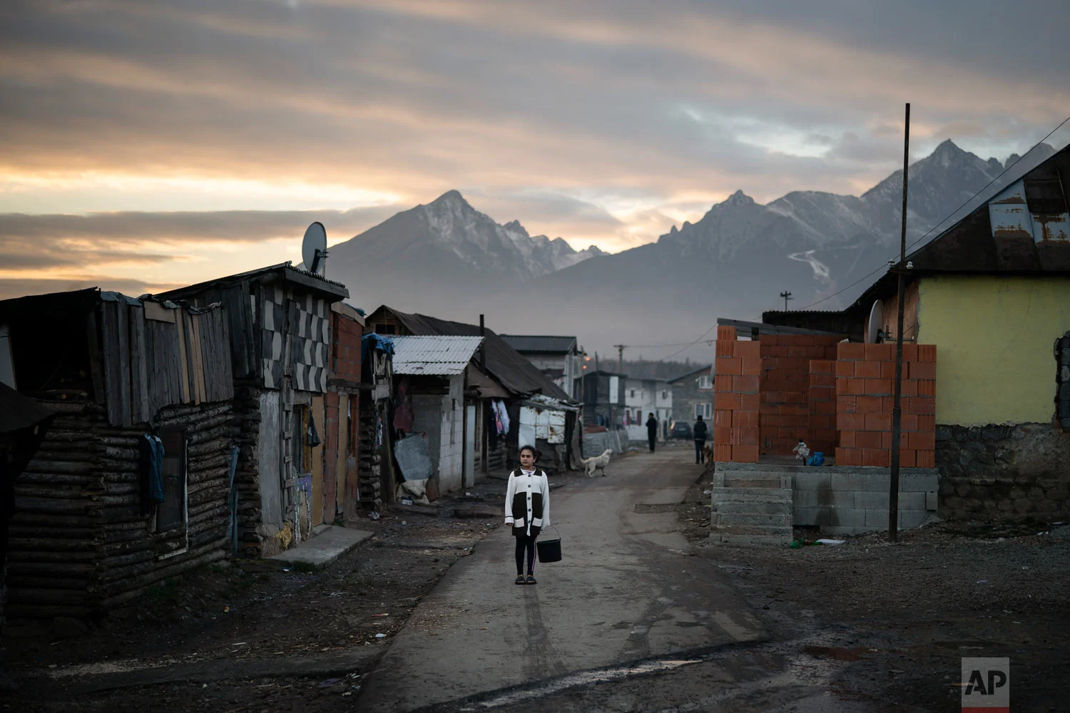 A Roma girl carries a bucket on Nov. 16, 2018, in a village near Kezmarok, Slovakia. (AP Photo/Felipe Dana)