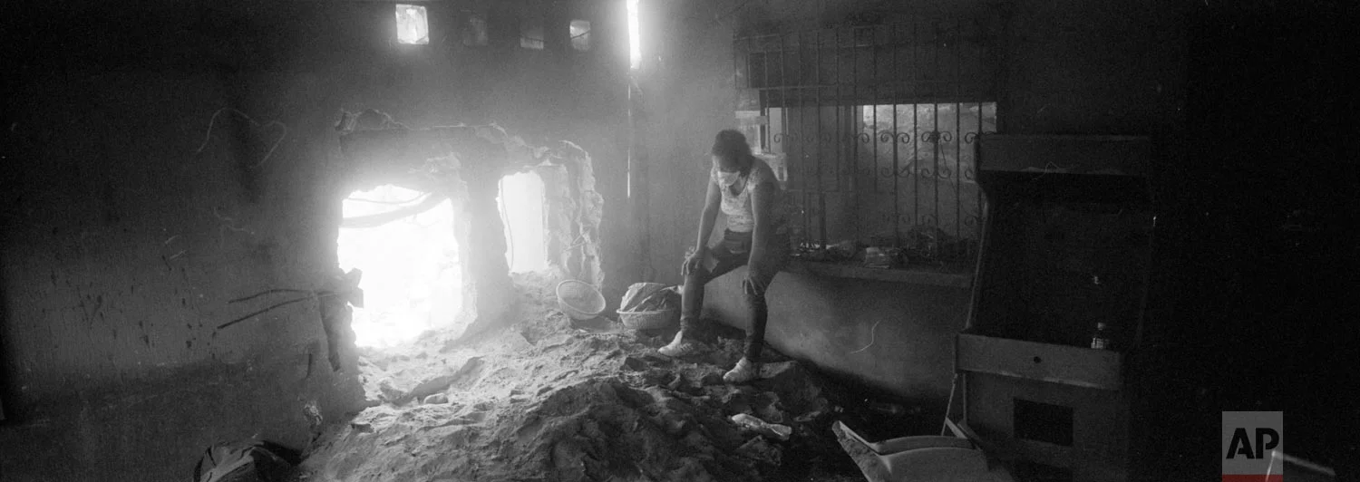 Angelica Maria Alvarez rests, exhausted, inside her home destroyed by the eruption of the the Volcan de Fuego or "Volcano of Fire," June 14, 2018, in San Miguel Los Lotes, Guatemala. Alvarez is still searching for the remains of more than 10 family members, including her husband and two daughters. (AP Photo/Rodrigo Abd)