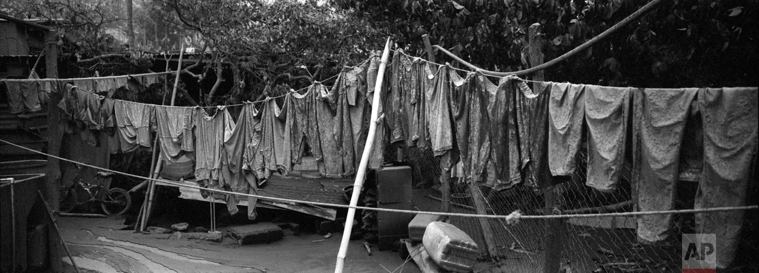 Apparel hung on a clothesline are covered in volcanic ash outside a home in the disaster zone near the Volcan de Fuego, or "Volcano of Fire, on June 6 in San Miguel Los Lotes, Escuintla, Guatemala. (AP Photo/Rodrigo Abd)