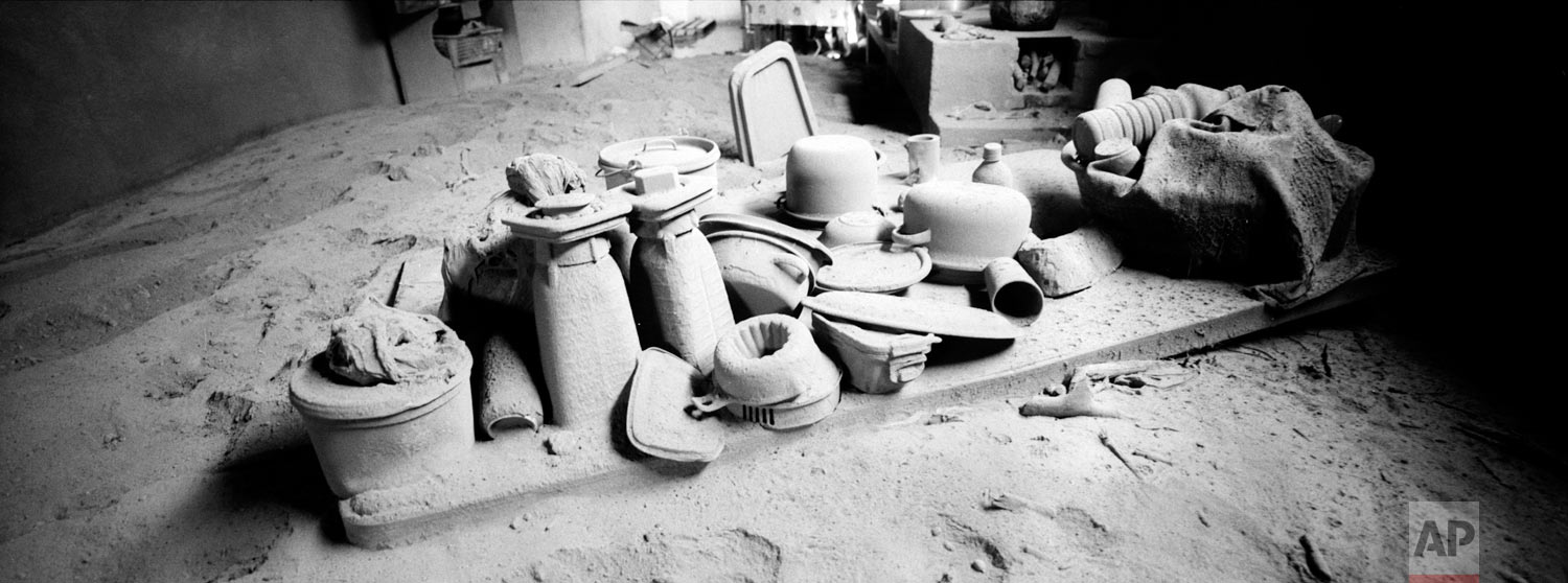 Kitchen utensils are coated with volcanic ash spewed by the Volcan de Fuego or Volcano of Fire, on June 9, 2018, in San Miguel Los Lotes, Guatemala. (AP Photo/Rodrigo Abd)