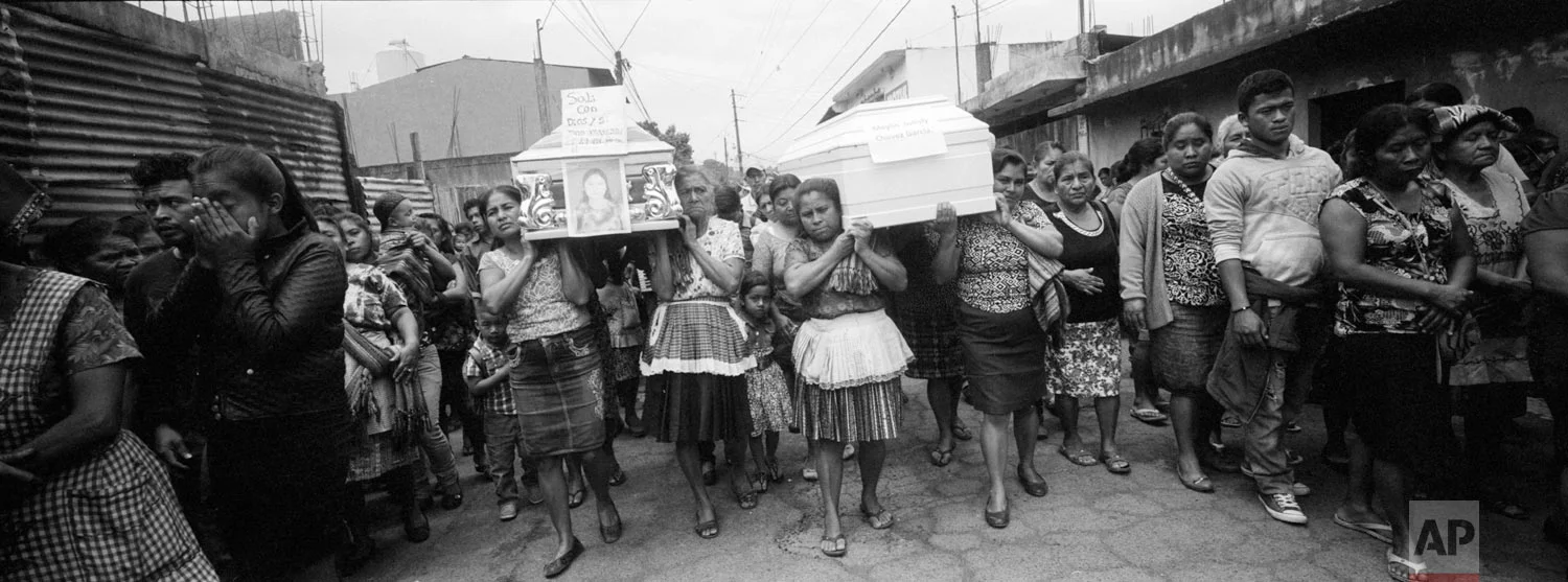 Villagers walk towards the cemetery with the remains of four people who died due to the eruption of the Volcan de Fuego, or Volcano of Fire, on June 10, 2018, in San Juan Alotenango, Guatemala. (AP Photo/Rodrigo Abd)