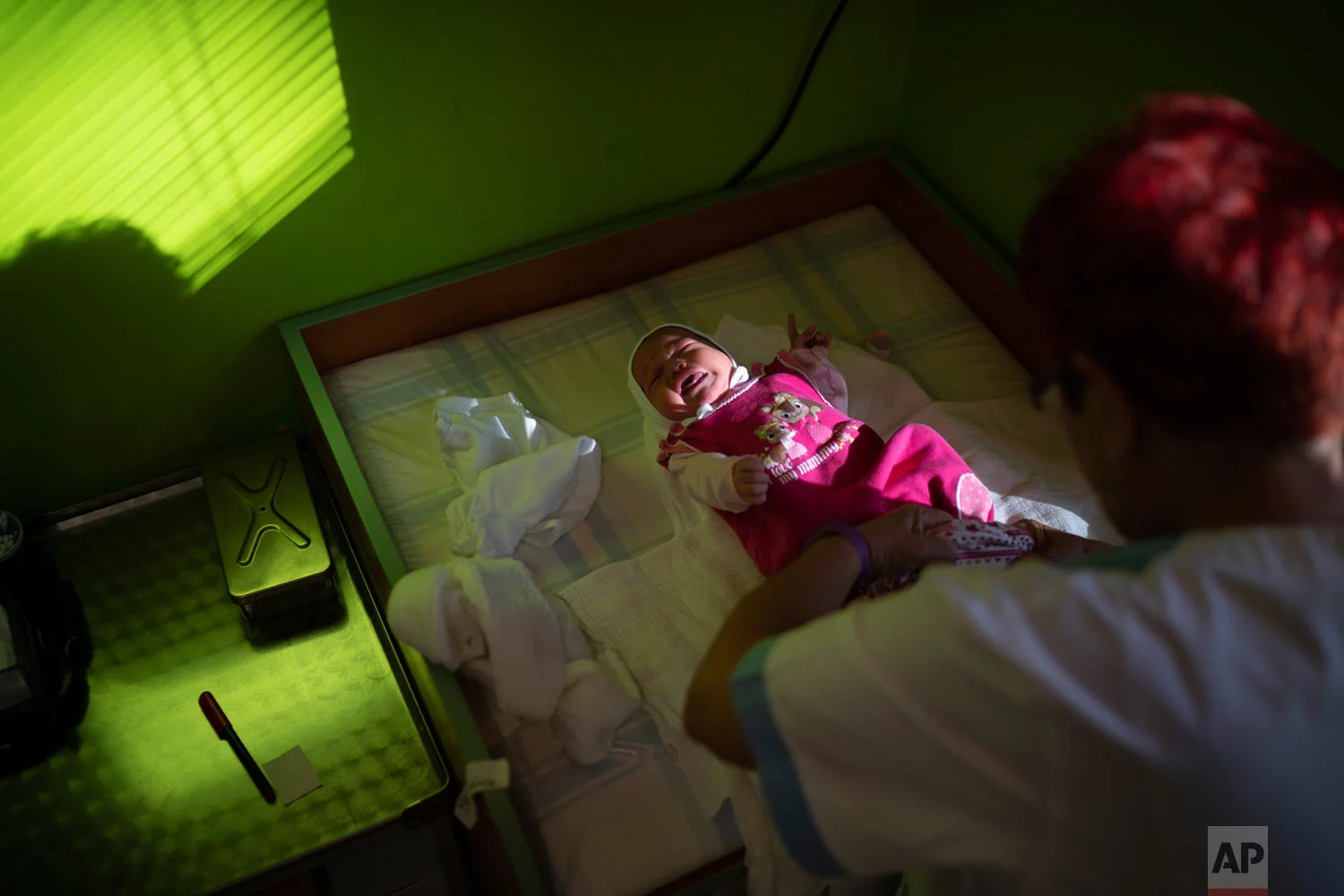 A nurse dresses a baby at the Kezmarok hospital on Nov. 16. 2018, in Kezmarok, Slovakia. (AP Photo/Felipe Dana)