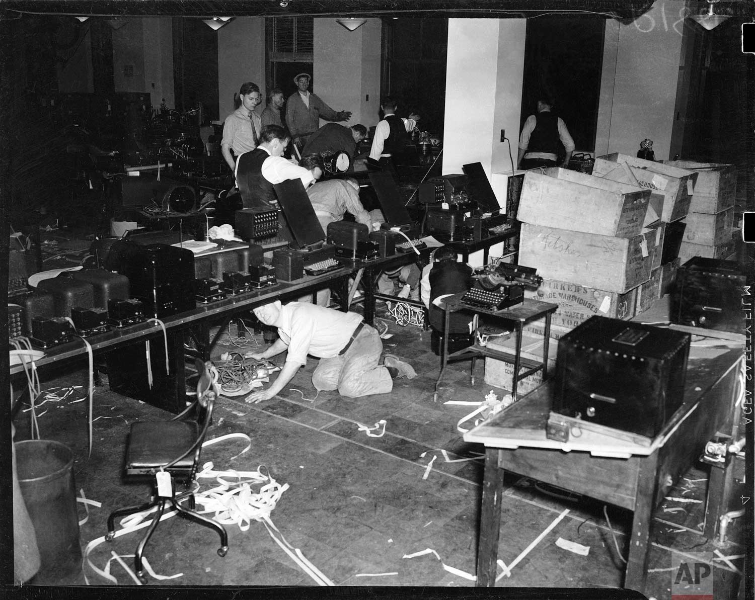  Workmen set up teletype machines in the newsroom at the new Associated Press building at Rockefeller Center, New York. (AP Photo/Corporate Archives) 