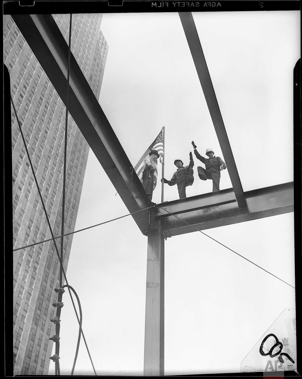  A "topping-out" ceremony - the raising of an American flag on the topmost girder - marked the completion of the steelwork on the 15-story new Associated Press building at Rockefeller Center, New York, June 16, 1938. (AP Photo/Corporate Archives/Jose