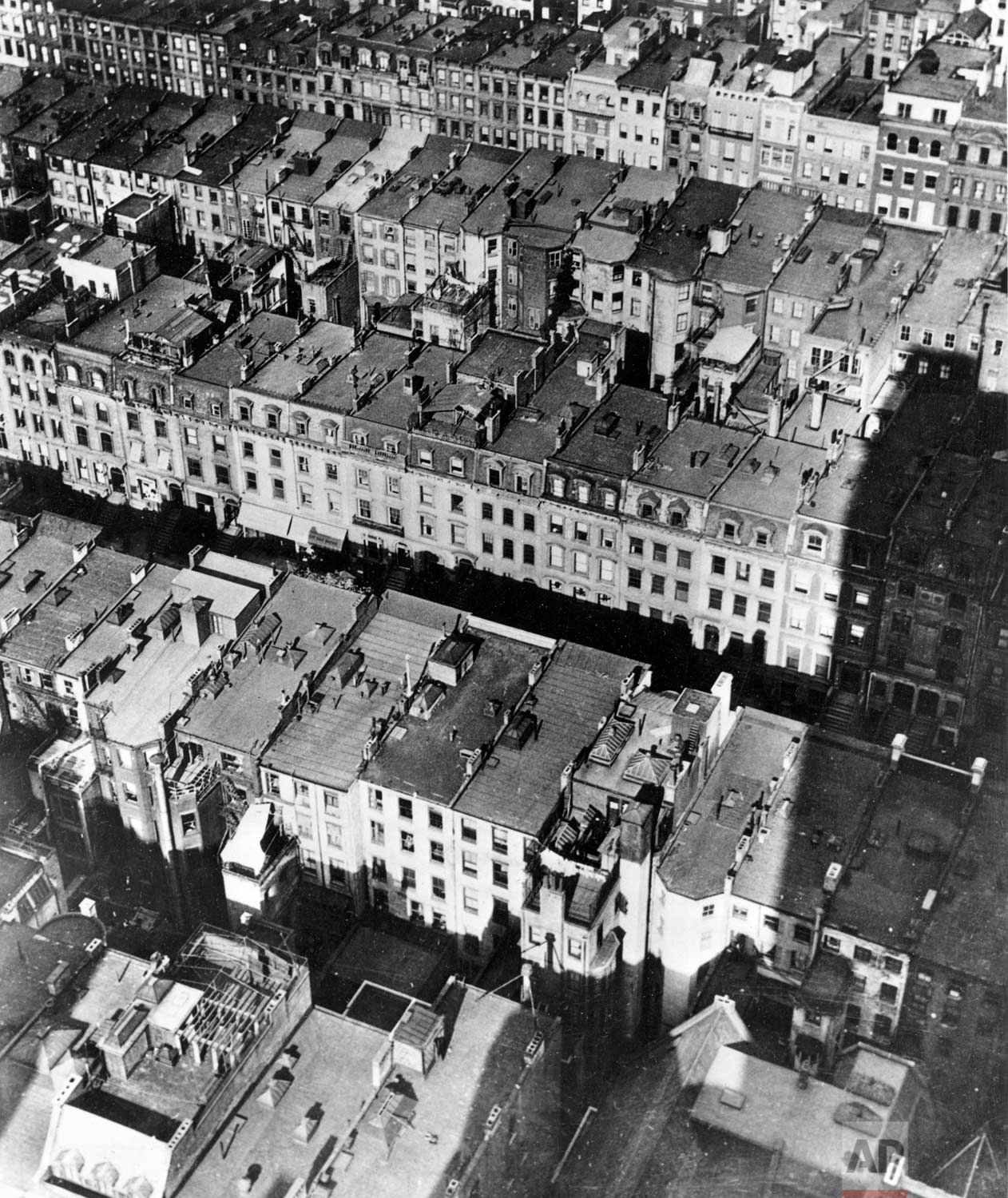  This aerial view shows the site of the projected Rockefeller Center in New York, prior to the beginning of demolition works, in June 1930. Two hundred and twenty-nine brownstone buildings are to be demolished in a three block area, stretching from W