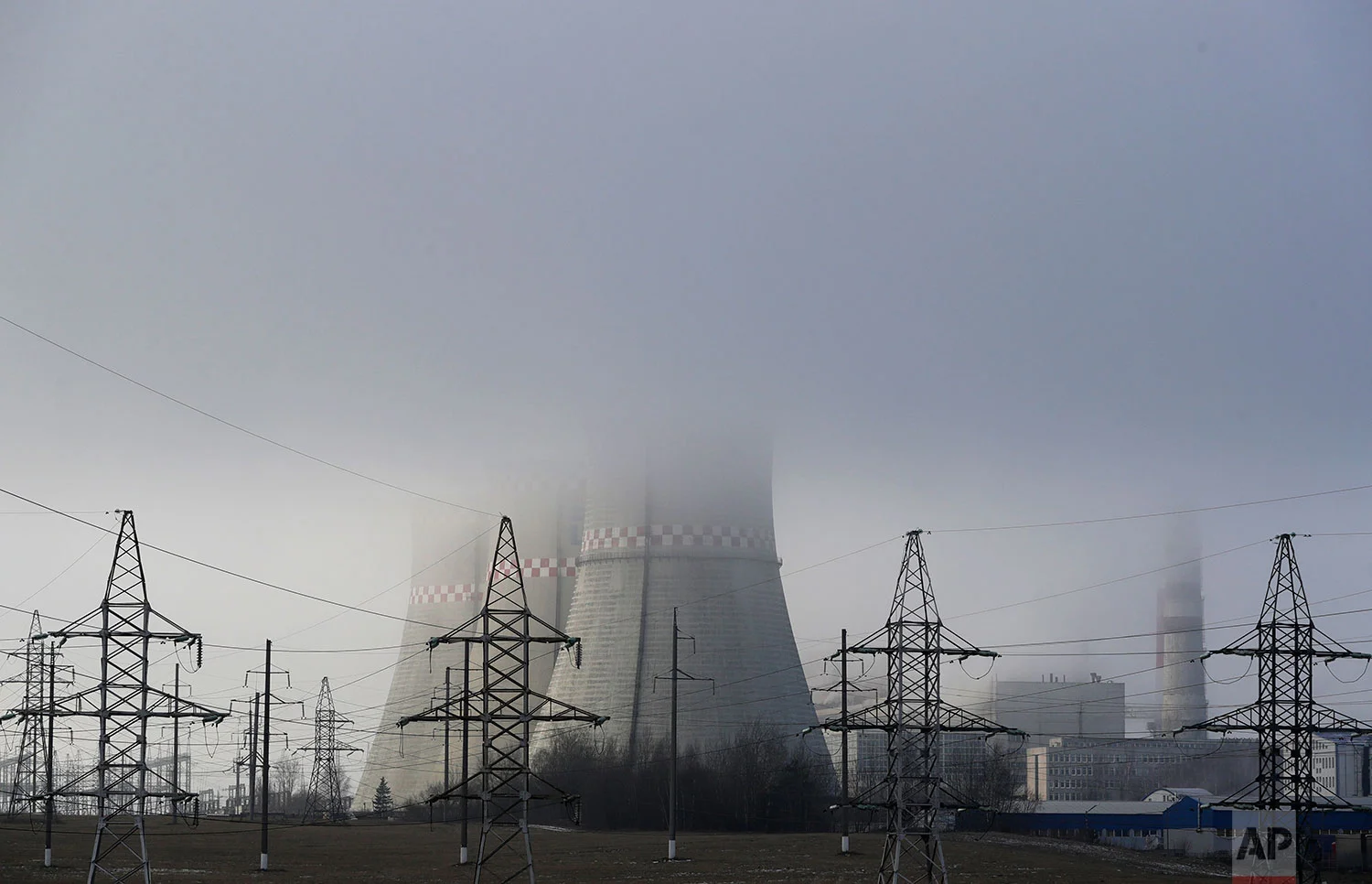 In this Thursday, Dec. 6, 2018 photo, a power plant is partially obscured by fog in Minsk, Belarus. (AP Photo/Sergei Grits)