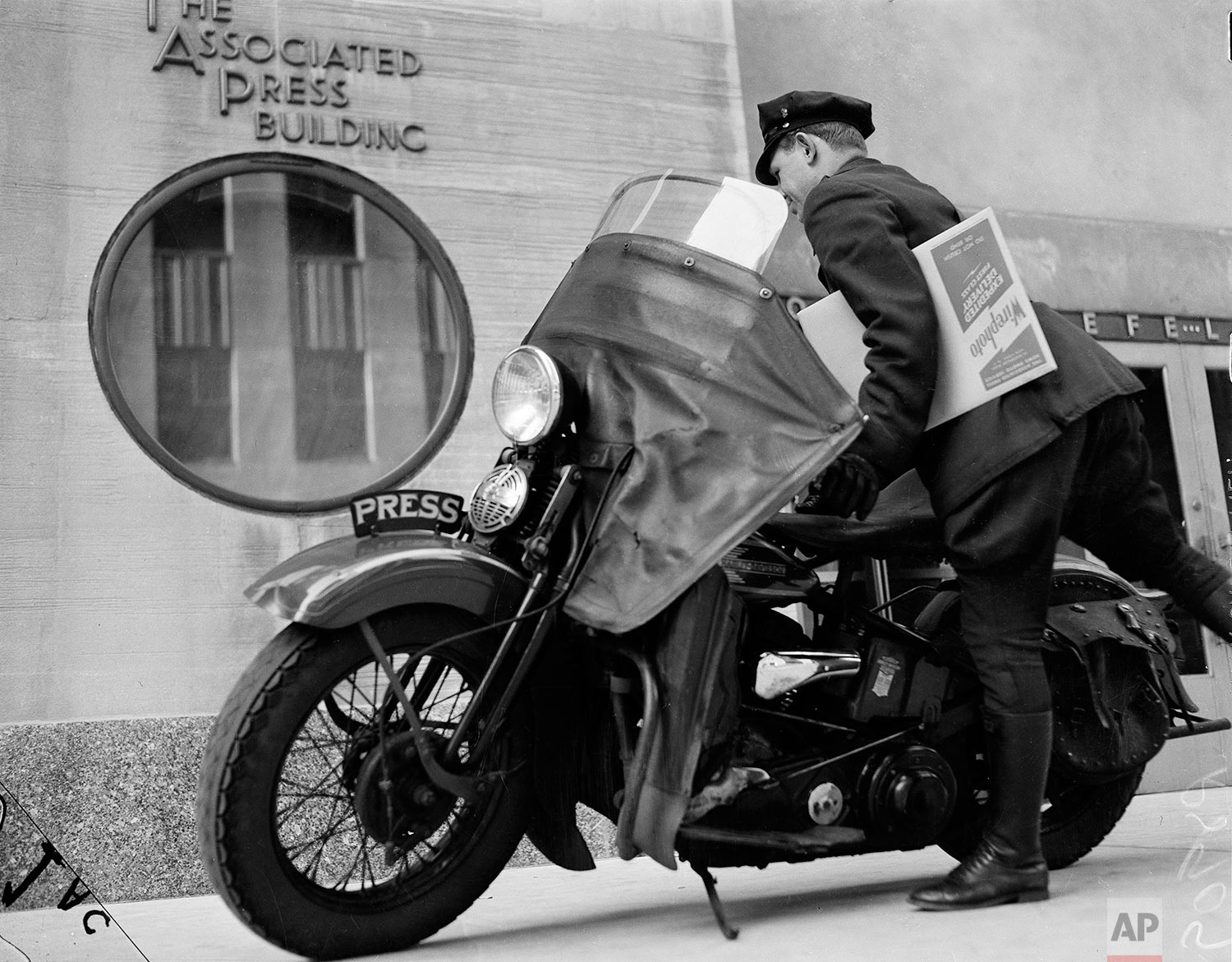  AP motorcycle messenger Pete Schivilla departs AP headquarters at 50 Rockefeller Plaza with a photo package destined for one of New York's daily newspapers in March 1939. Although the AP had been transmitting photos by wire for four years, competiti