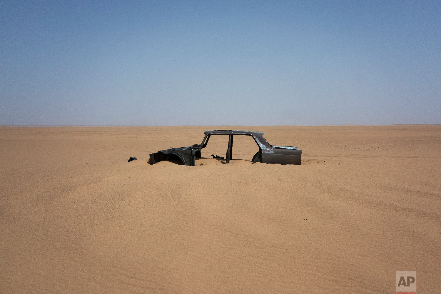 The frame of an abandoned Peugeot 404 rests in Niger's Tenere desert region of the south central Sahara on June 3, 2018. (AP Photo/Jerome Delay) 