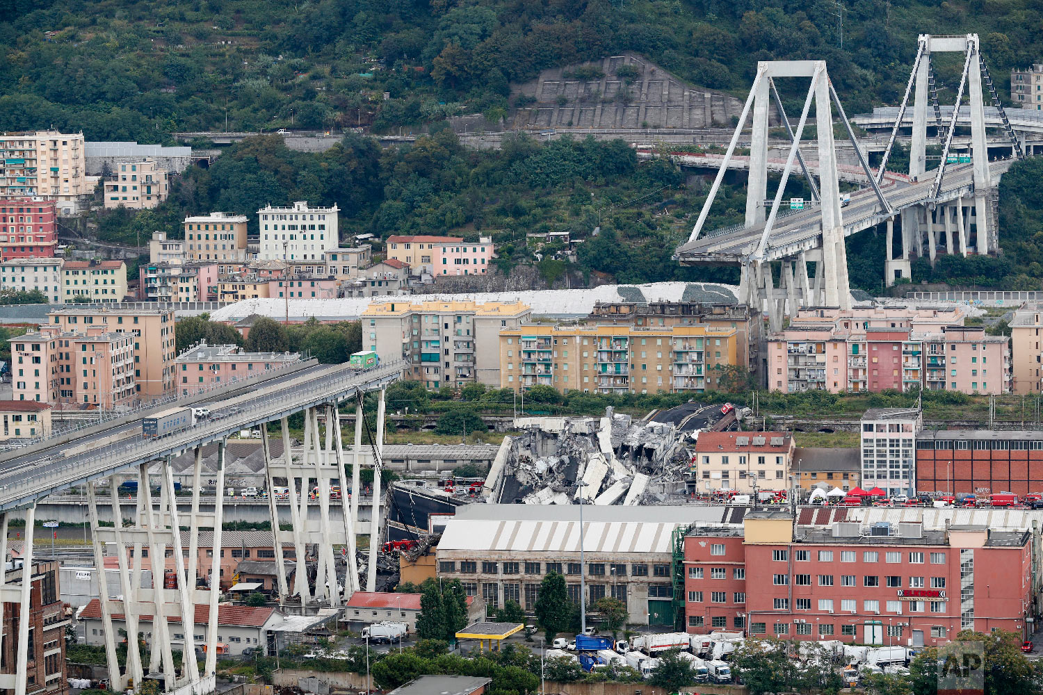  Cars are blocked on the Morandi highway bridge after a section of it collapsed, in Genoa, northern Italy. (AP Photo/Antonio Calanni) 