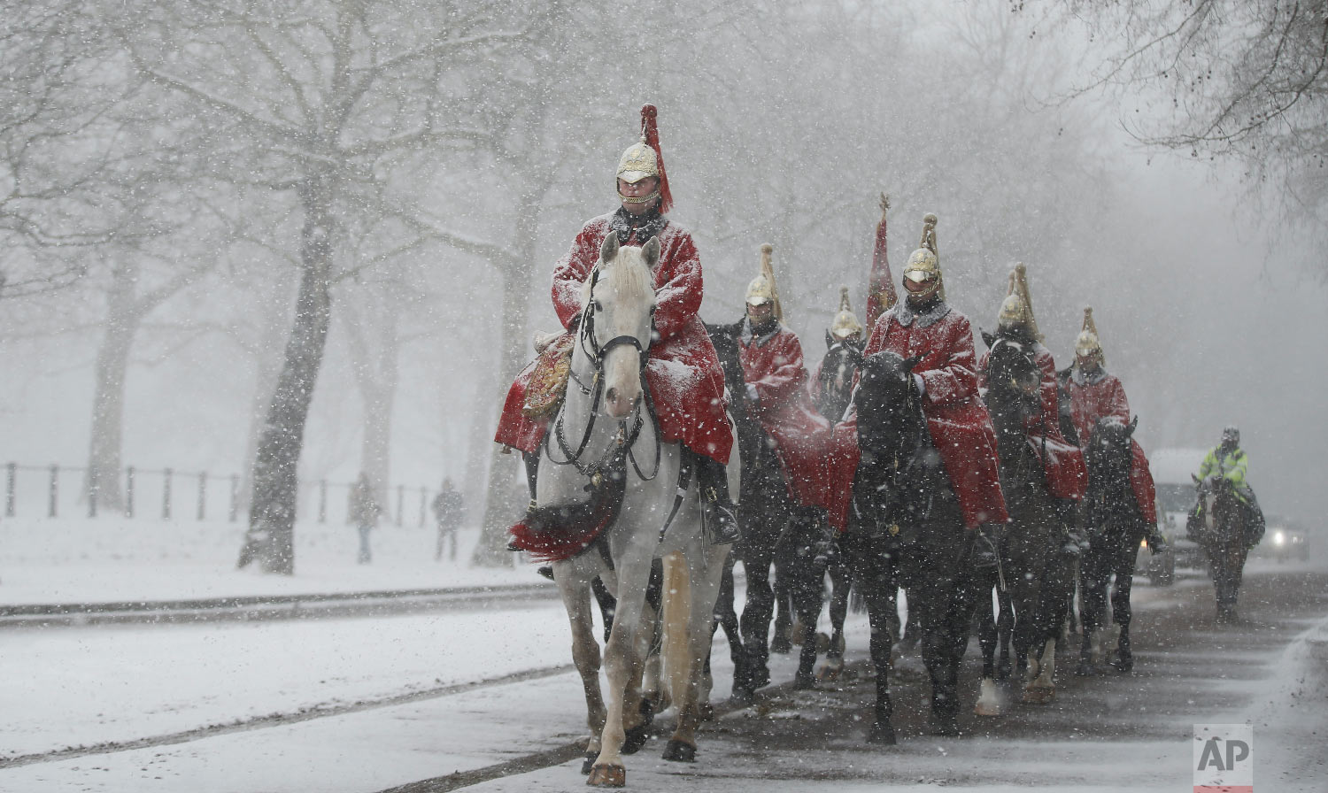  Members of the Household Cavalry return to their barracks as snow falls in London. Britain, which is buffered by the Atlantic Ocean and tends to have temperate winters, saw heavy snow in some areas that disrupted road, rail and air travel and forced