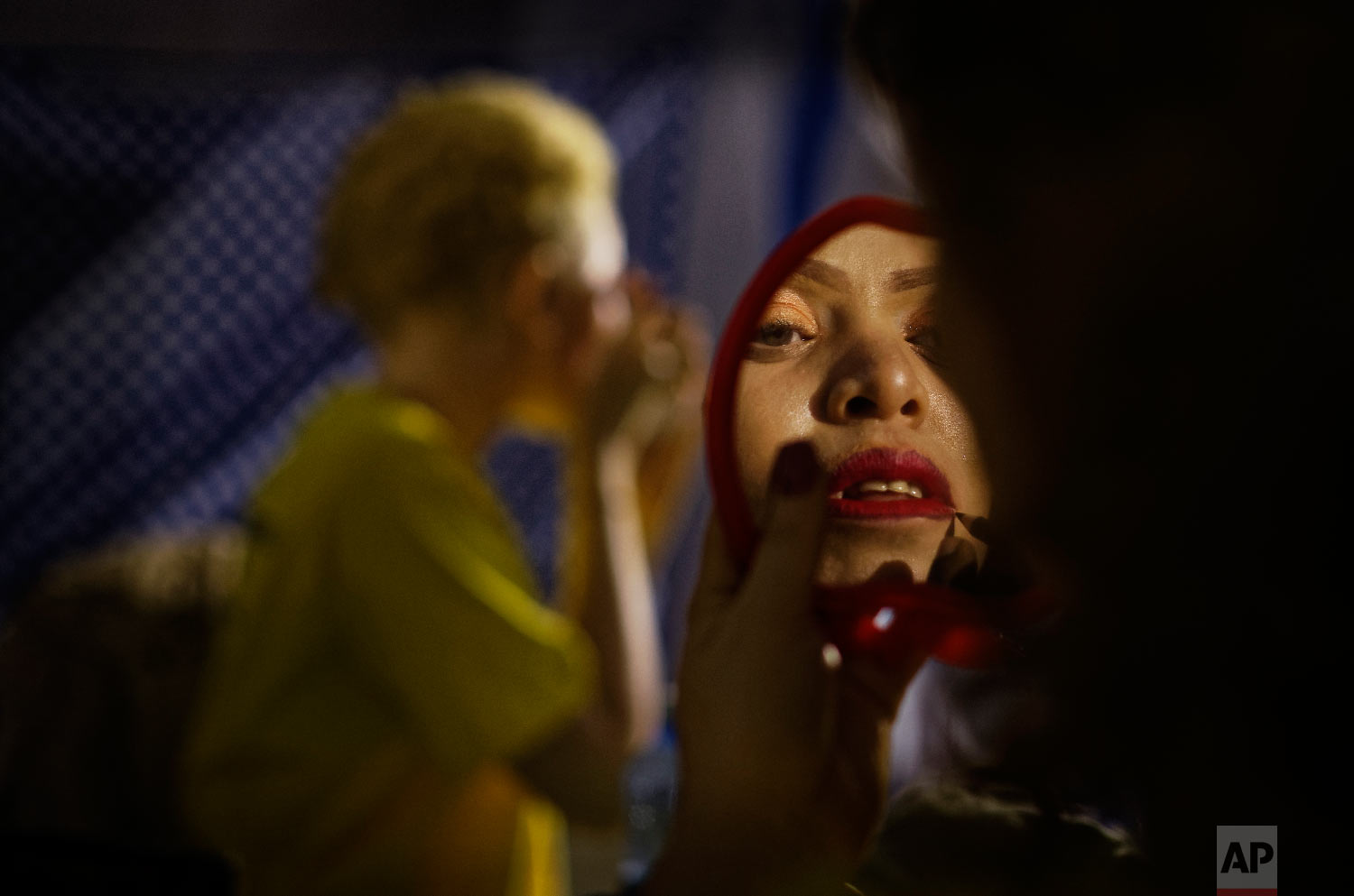  A contestant checks her makeup in a mirror as she prepares to perform in the "Mr. &amp; Miss Albinism East Africa" contest, organized by the Albinism Society of Kenya, in Nairobi, Kenya on Nov. 30, 2018. (AP Photo/Ben Curtis) 