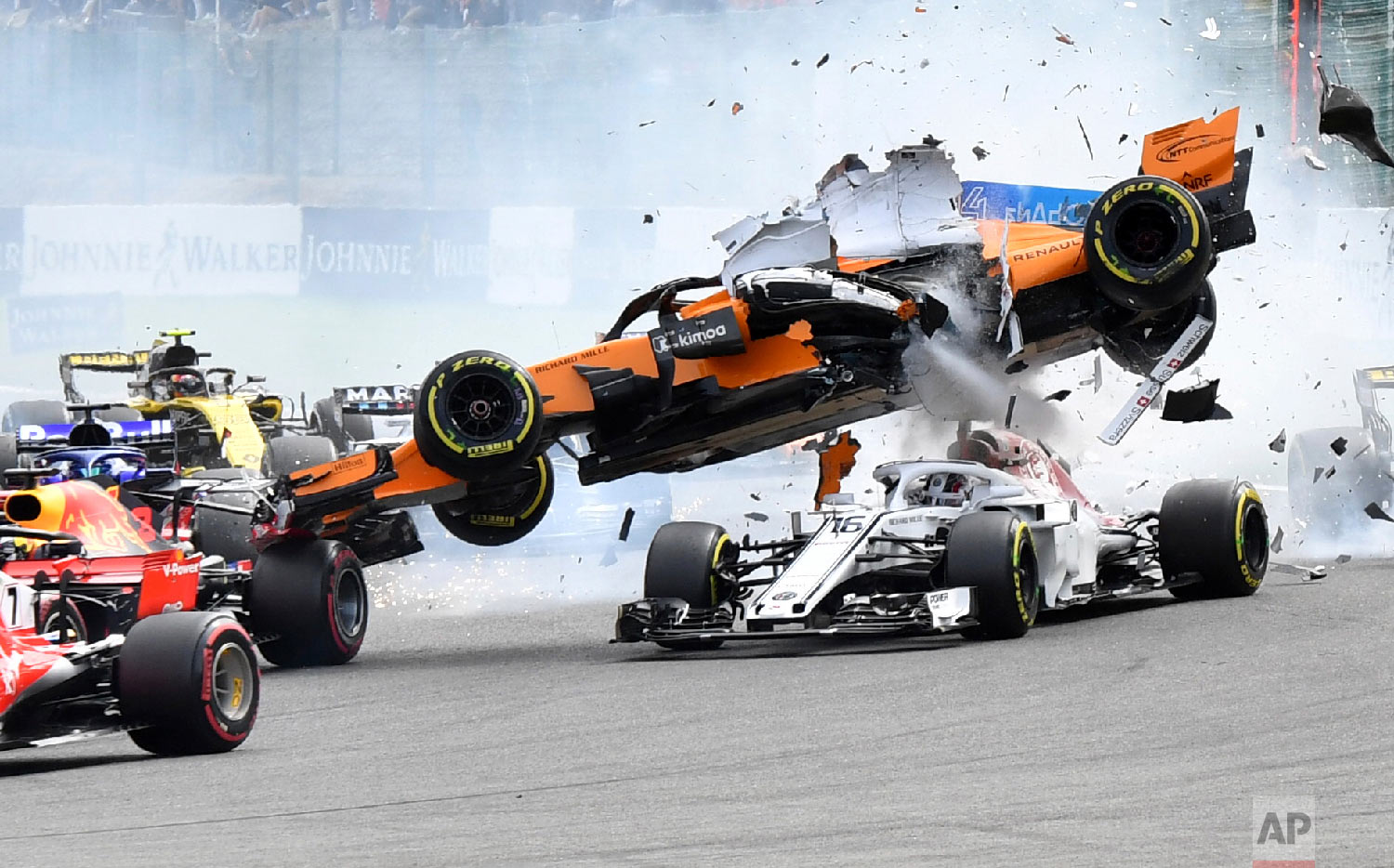  Mclaren driver Fernando Alonso of Spain, top, goes over the top of Sauber driver Charles Leclerc of Monaco as they are involved in a crash at the start of the Belgian Formula One Grand Prix in Spa-Francorchamps, Belgium on Aug. 26, 2018. (AP Photo/G