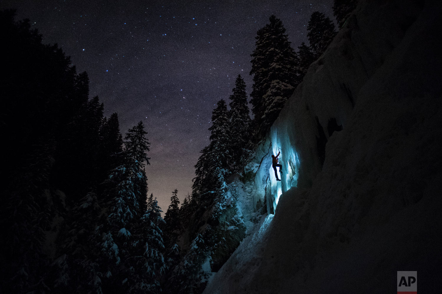 Pierre, a member of Team Arnicare, climbs an Ice Cascade during a night-time training session under a stary night near La Lecherette in the Hongrin region, in canton Vaud, Switzerland on Feb. 14, 2018. (Anthony Anex/Keystone via AP) 