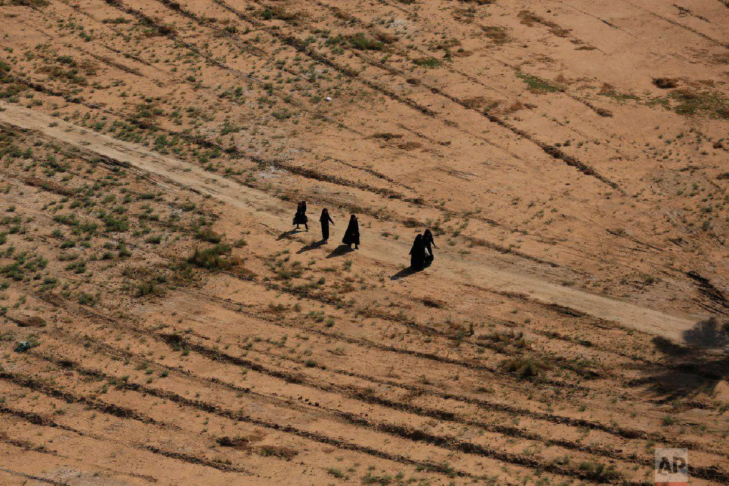 Shiite pilgrims march to their holy shrines for Arbaeen, outside Karbala, Iraq, Oct. 29, 2018. The annual commemoration, called Arbaeen, brings more pilgrims each year than the Hajj, in Saudi Arabia, yet it is hardly known outside Islam. (AP Photo/Hadi Mizban)