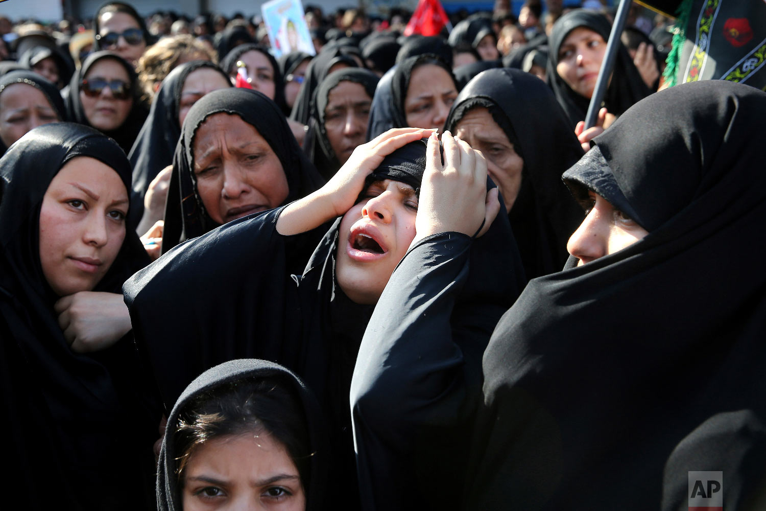 Families of victims of a terror attack on a military parade in the southwestern city of Ahvaz, that killed 25 people attend a mass funeral ceremony, in Ahvaz, Iran, Sept. 24, 2018. (AP Photo/Ebrahim Noroozi)